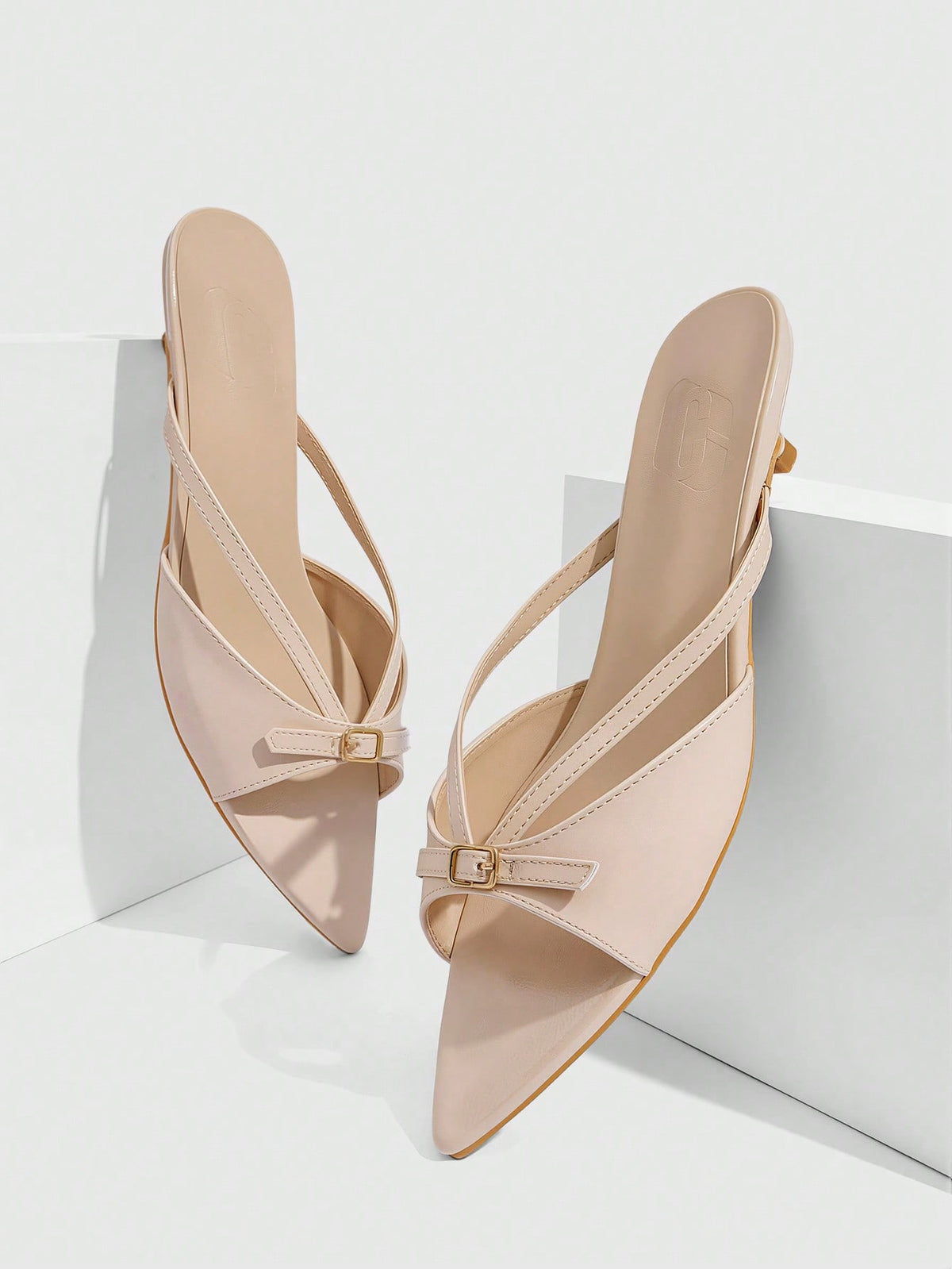 Pointed toe high-heeled slippers in PU leather with decorative buckle detail and low kitten heels for women.