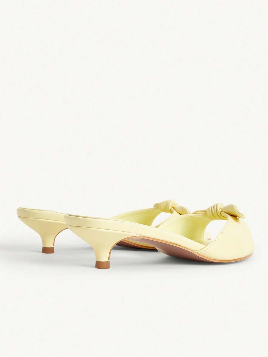Pointed toe high-heeled slippers in PU leather with decorative buckle detail and low kitten heels for women.
