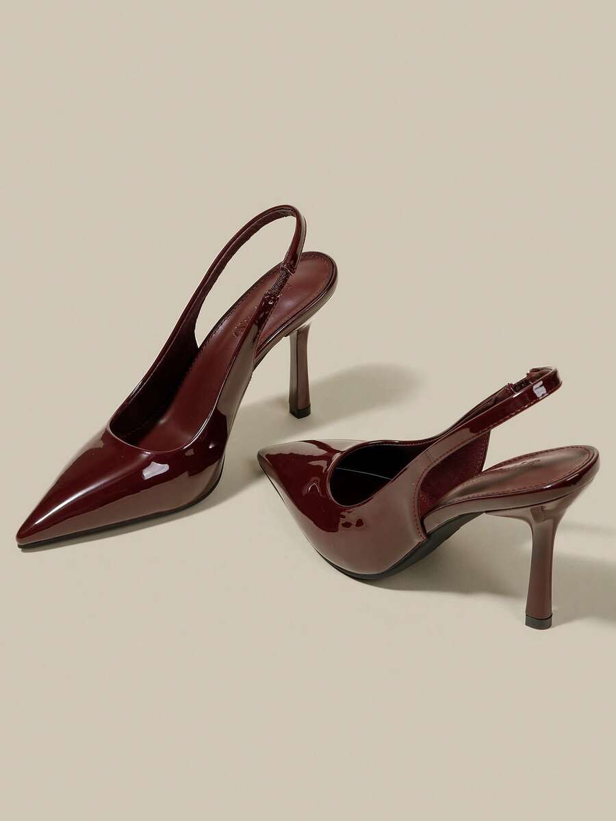 Women's pointed toe kitten heel pumps with adjustable buckle back strap and sleek patent finish.