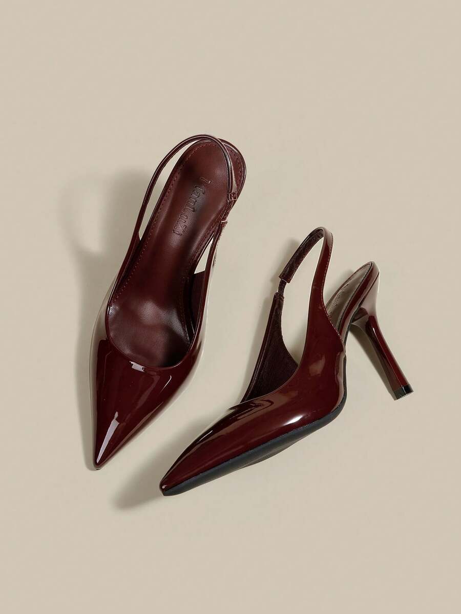 Women's pointed toe kitten heel pumps with adjustable buckle back strap and sleek patent finish.