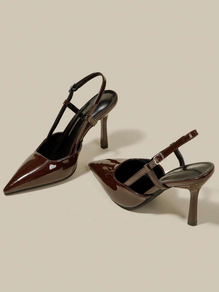 Women's pointed toe kitten heel pumps with adjustable buckle back strap and sleek patent finish.