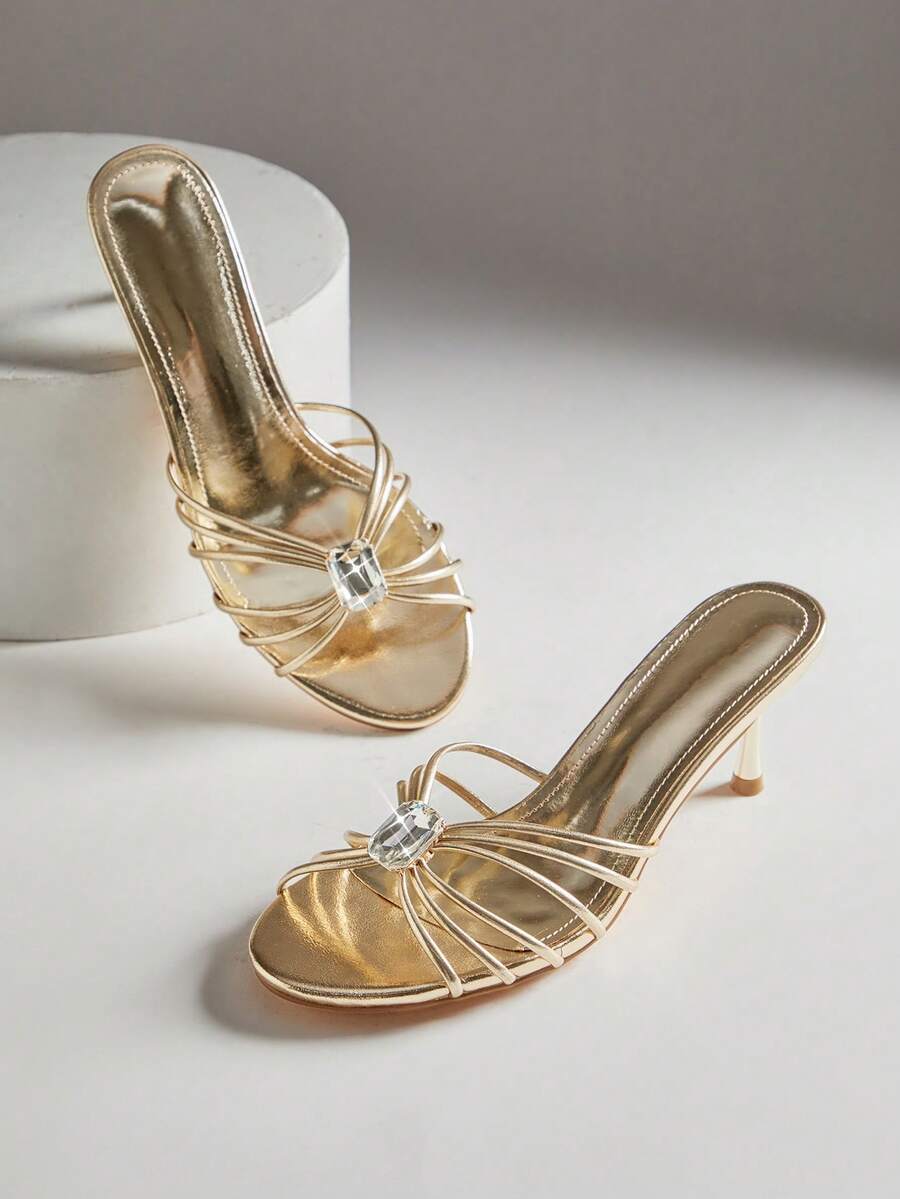 Black pointy toe kitten heel shoes for women featuring a sleek cut out mule design and glossy patent leather finish.