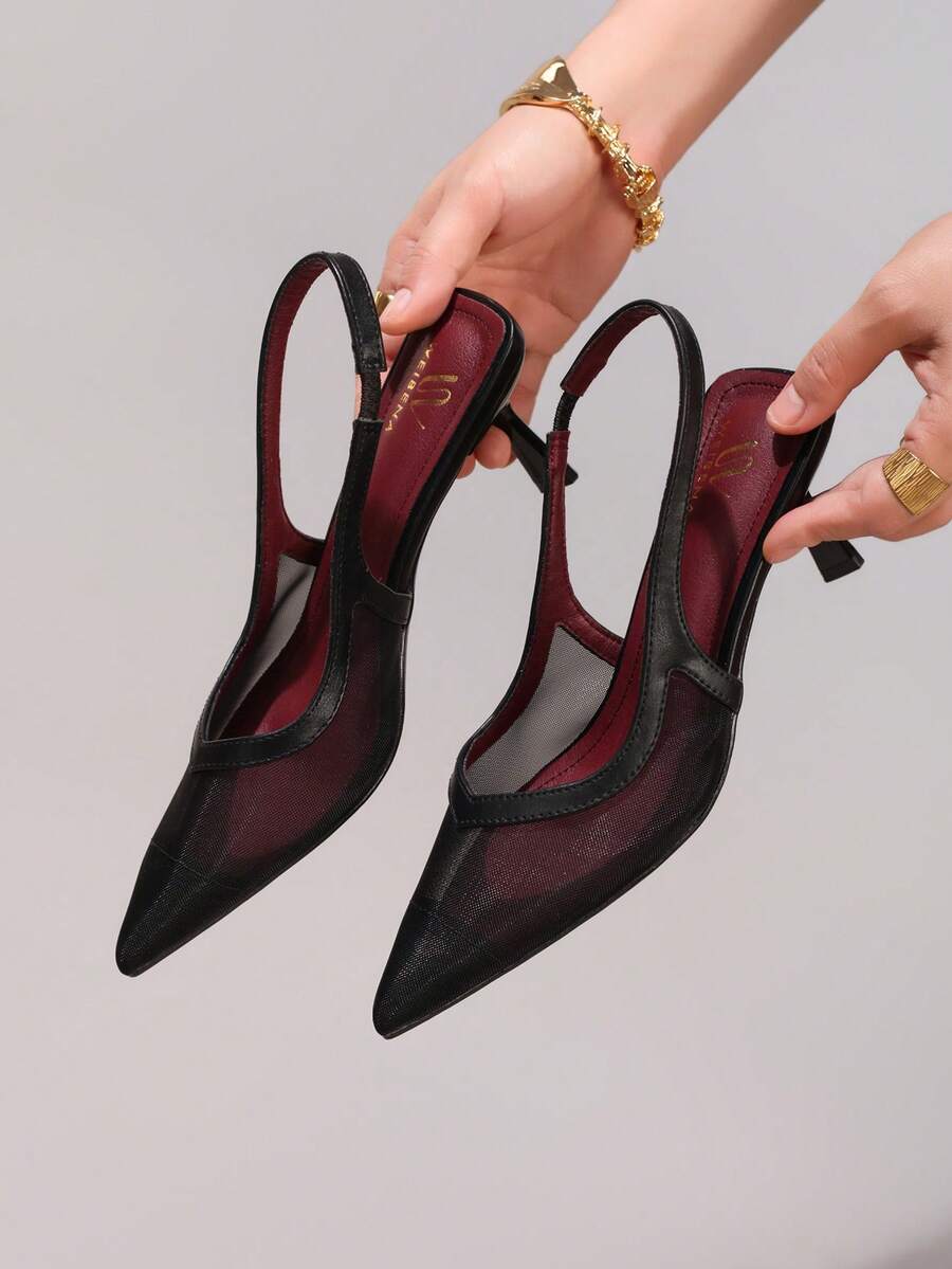 Pair of women's white pointed-toe kitten heel pumps with slingback straps and sleek patent finish
