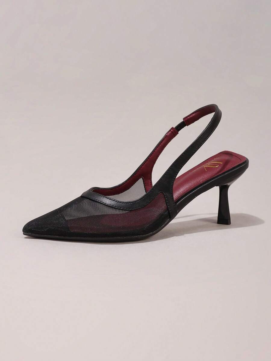 Pair of women's white pointed-toe kitten heel pumps with slingback straps and sleek patent finish