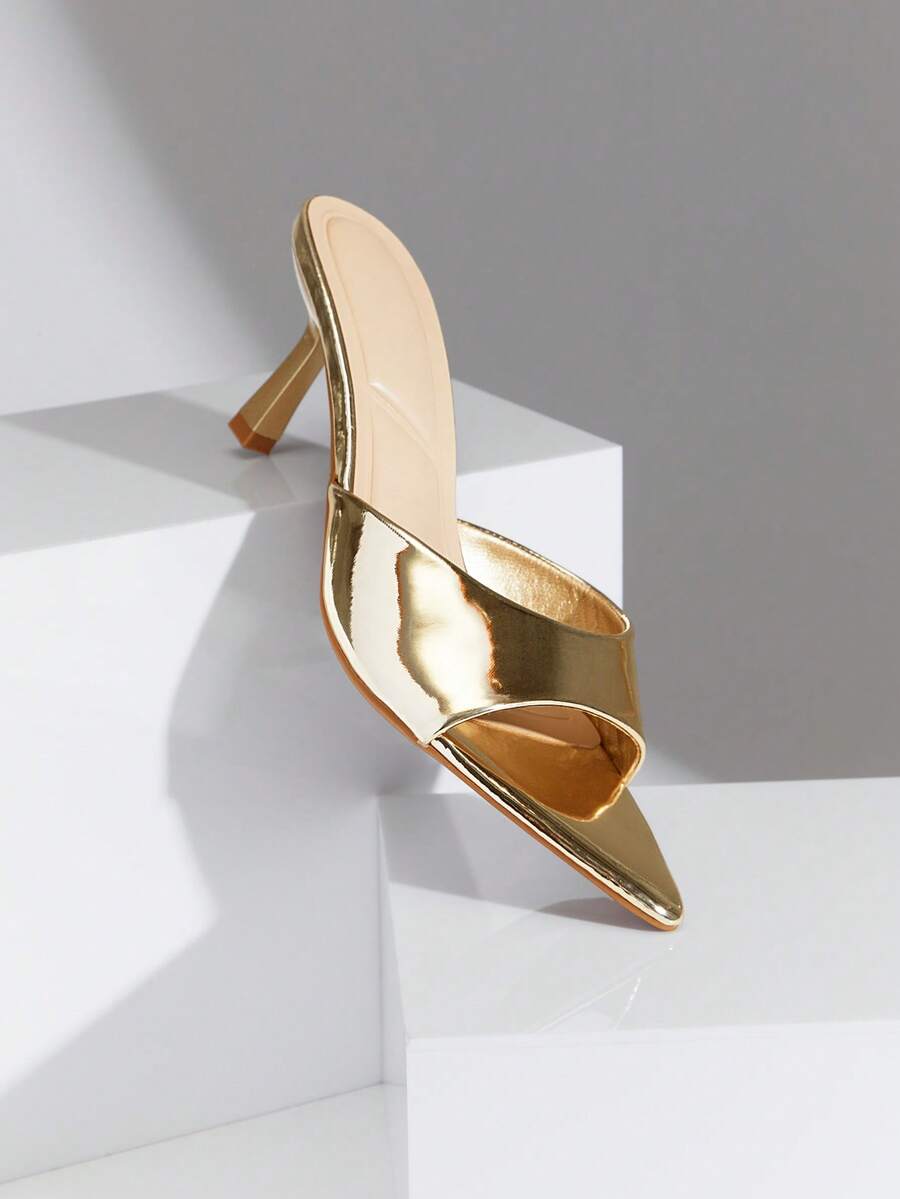 Black pointy toe kitten heel shoes for women featuring a sleek cut out mule design and glossy patent leather finish.