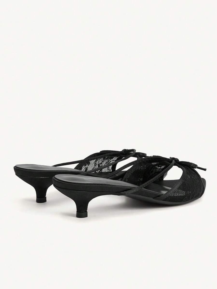 Pointed toe high-heeled slippers in PU leather with decorative buckle detail and low kitten heels for women.
