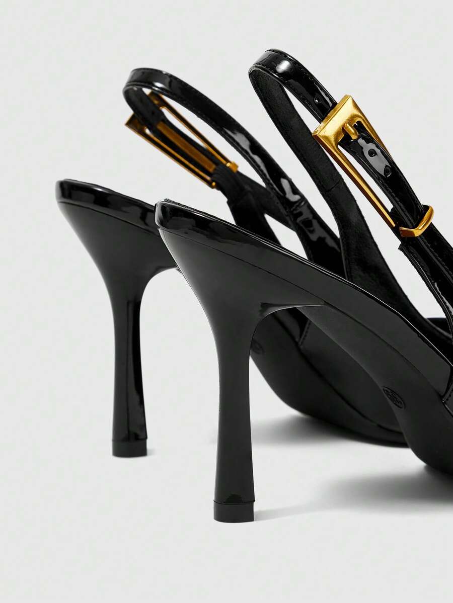 Women's pointed-toe high heel pumps in black mirror PU leather with an ankle strap, stiletto heel, and rhinestone buckle.