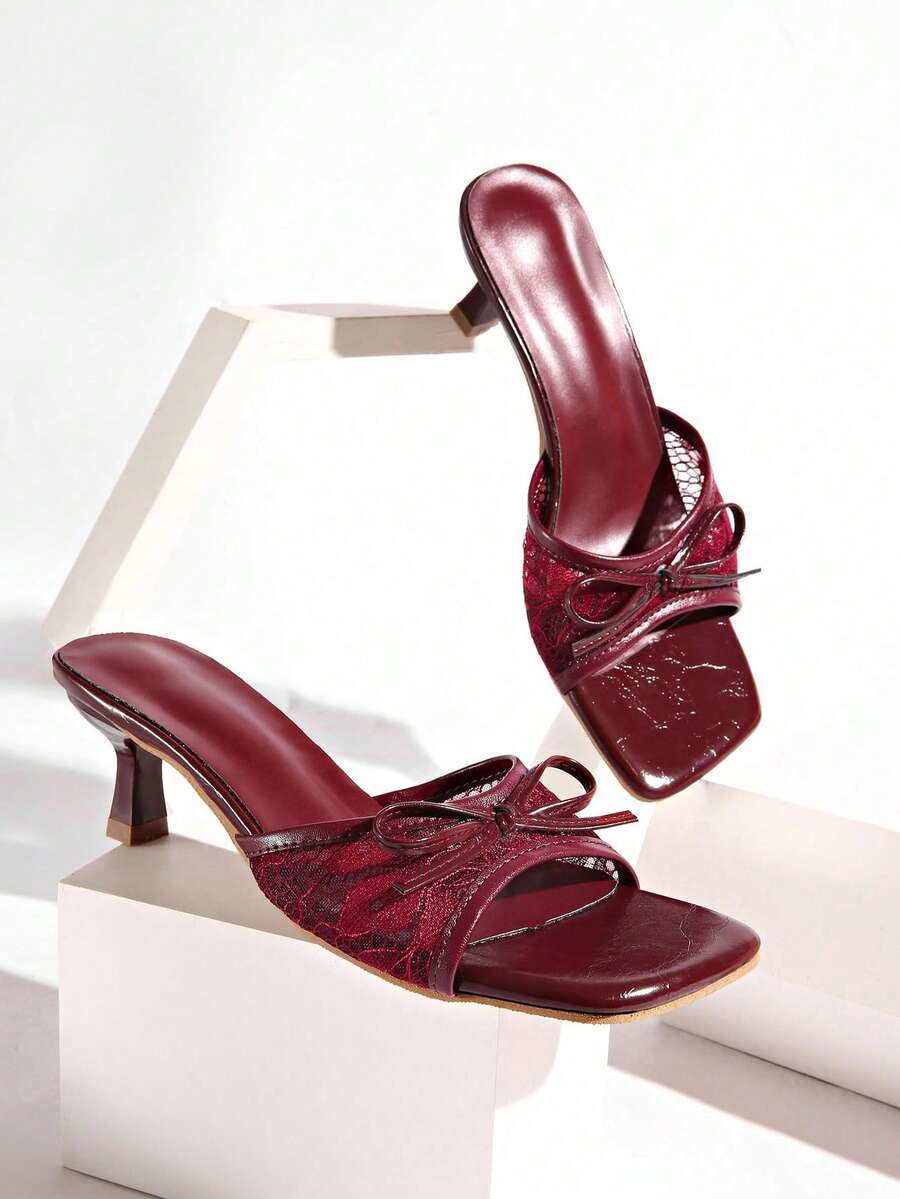 Gold kitten heel mule sandals featuring lace mesh bow detail and an open-toe slip-on design for women.