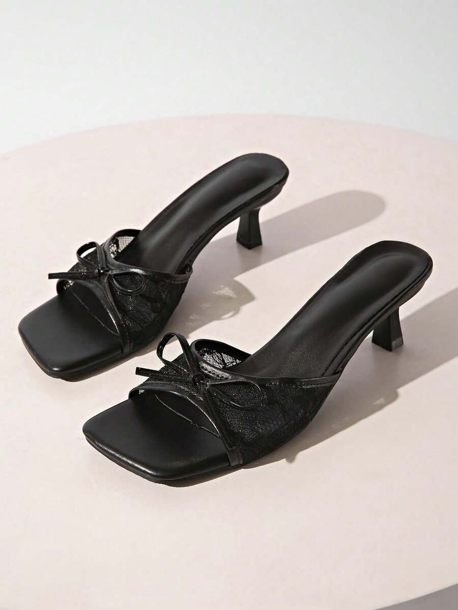 Gold kitten heel mule sandals featuring lace mesh bow detail and an open-toe slip-on design for women.