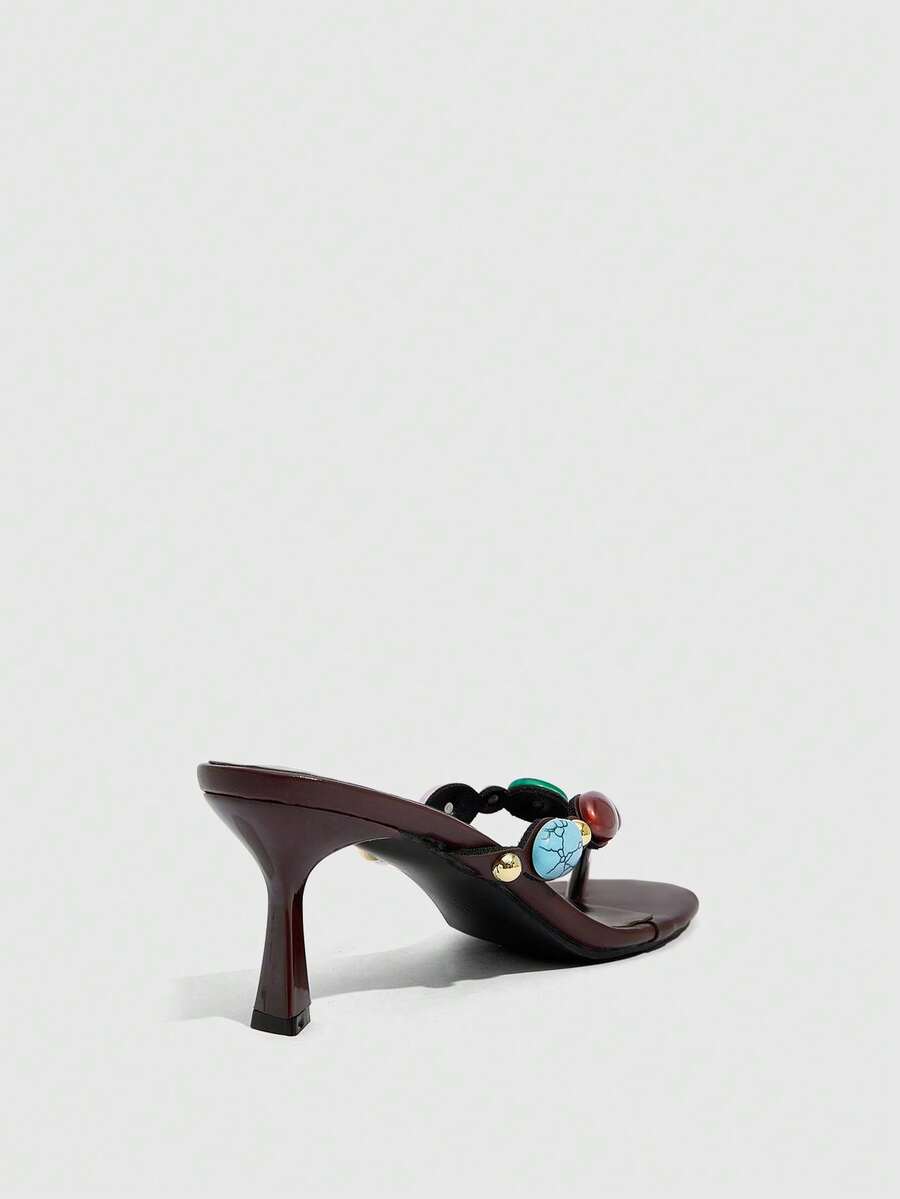 Elegant ladies strappy high-heeled slippers featuring a sleek toe post, buckle accent, and stiletto mid heel in smooth PU leather.