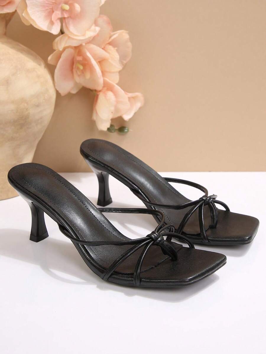 Women's slip-on mule heel sandals featuring knotted criss-cross strappy thong design, square open toe, and mid kitten heel.