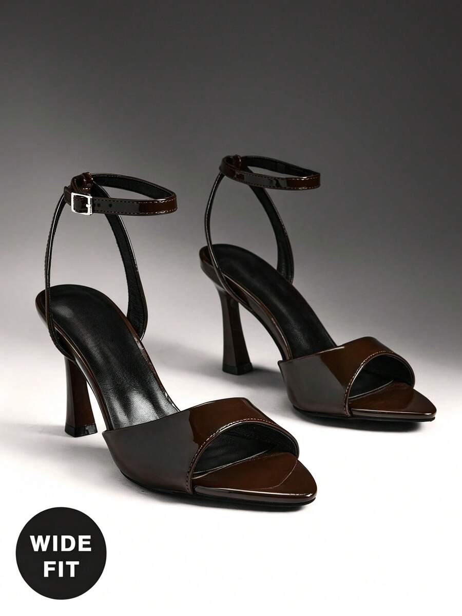 Women's wide-fit stiletto heel sandals featuring an open-toe design, slender mid stiletto heel, and adjustable ankle strap.