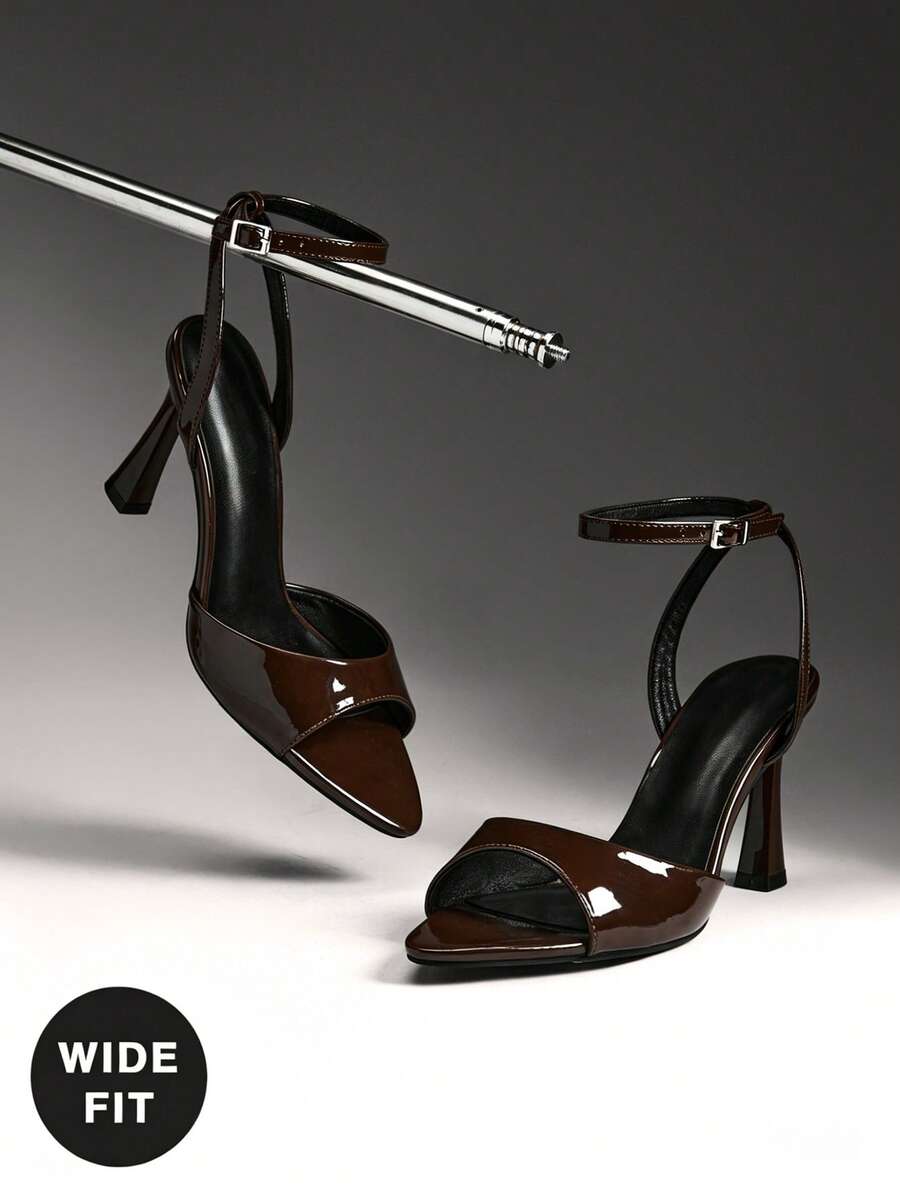 Women's wide-fit stiletto heel sandals featuring an open-toe design, slender mid stiletto heel, and adjustable ankle strap.
