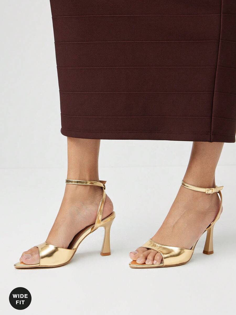 Women's wide-fit stiletto heel sandals featuring an open-toe design, slender mid stiletto heel, and adjustable ankle strap.