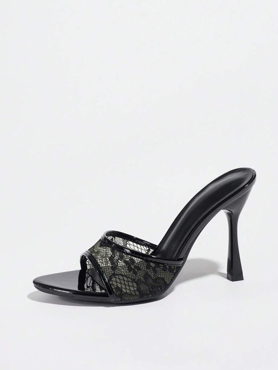 Women's black open toe stiletto heel sandals featuring lace mesh detailing, wide strap styling, and high stiletto heels.