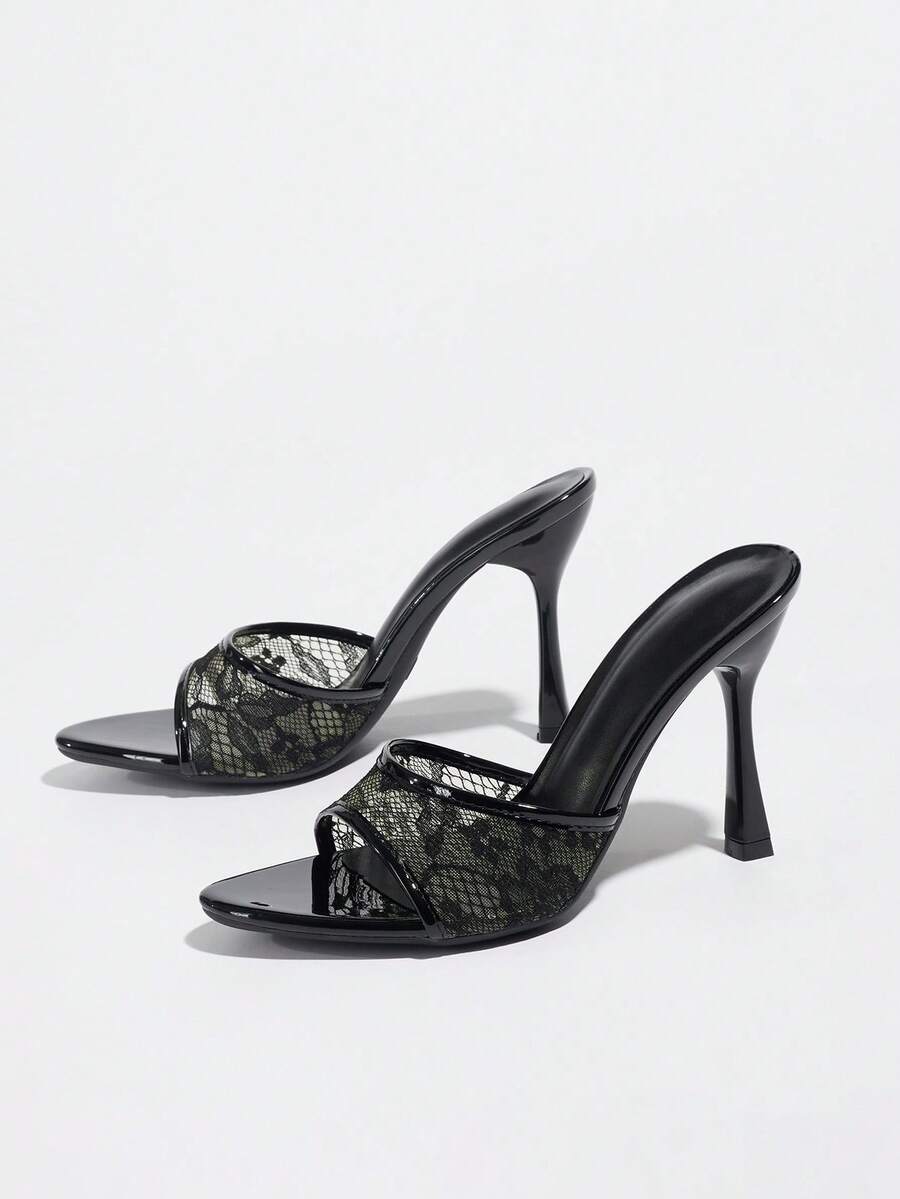 Women's black open toe stiletto heel sandals featuring lace mesh detailing, wide strap styling, and high stiletto heels.