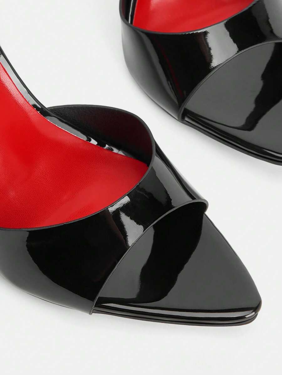 Black pointed toe high heel mules featuring transparent pyramid decor and stiletto heels for women.