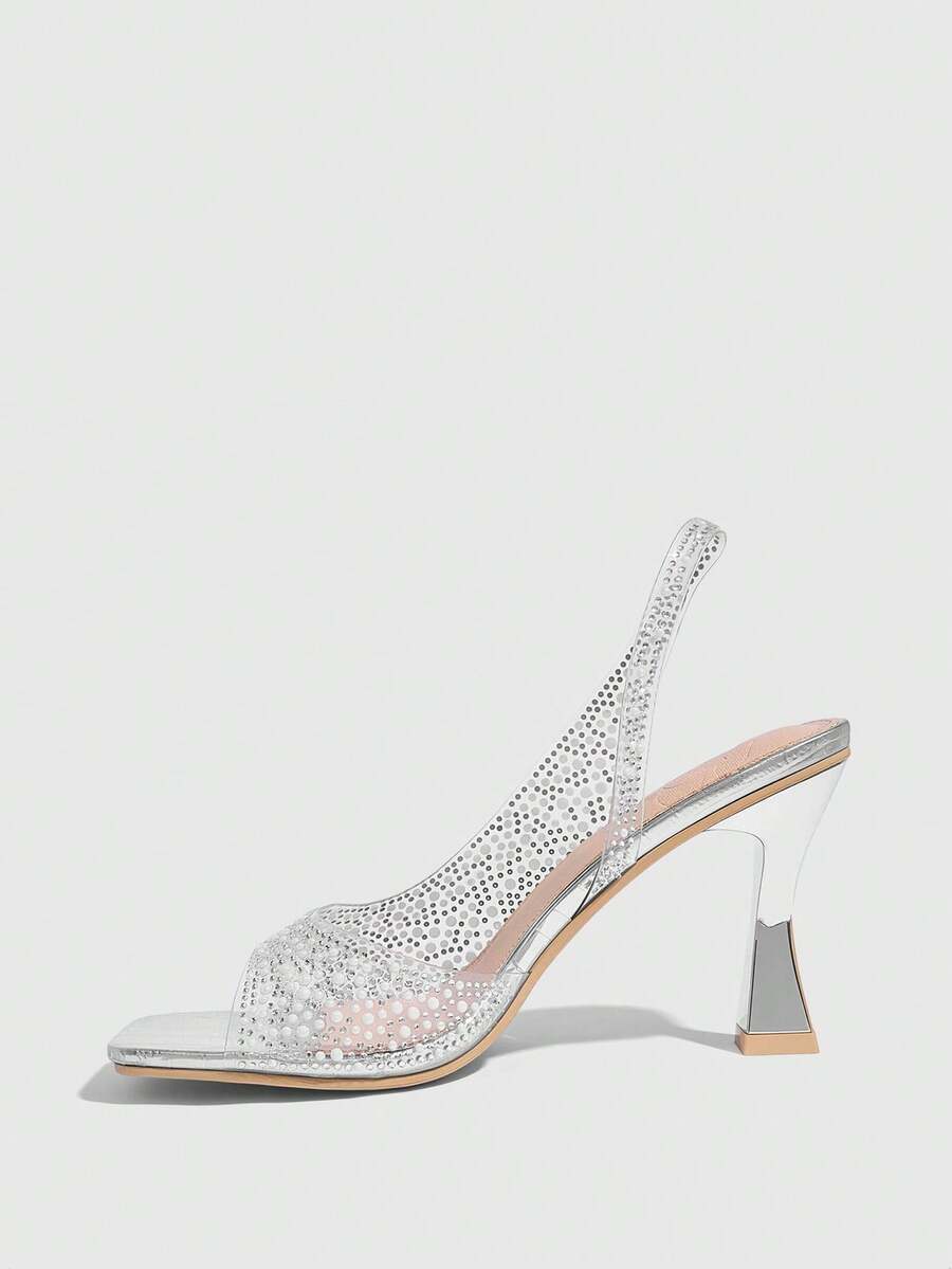 Women's square toe heeled sandals with clear straps, sparkling rhinestone embellishments, and a high pyramid heel.