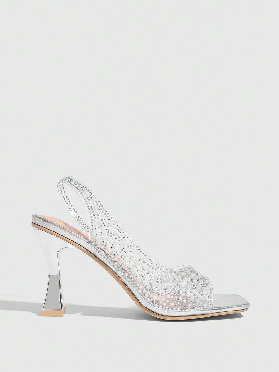 Women's square toe heeled sandals with clear straps, sparkling rhinestone embellishments, and a high pyramid heel.