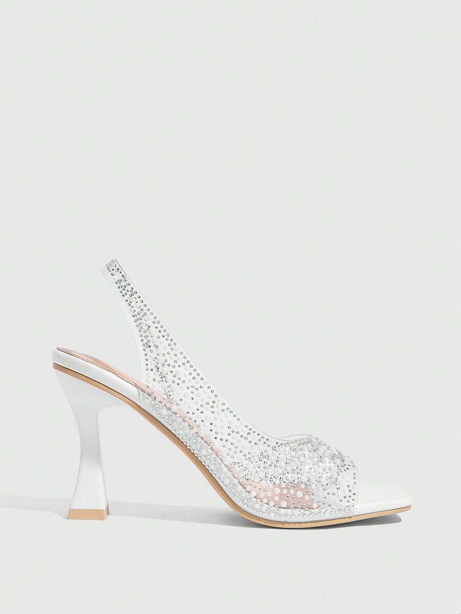 Women's square toe heeled sandals with clear straps, sparkling rhinestone embellishments, and a high pyramid heel.