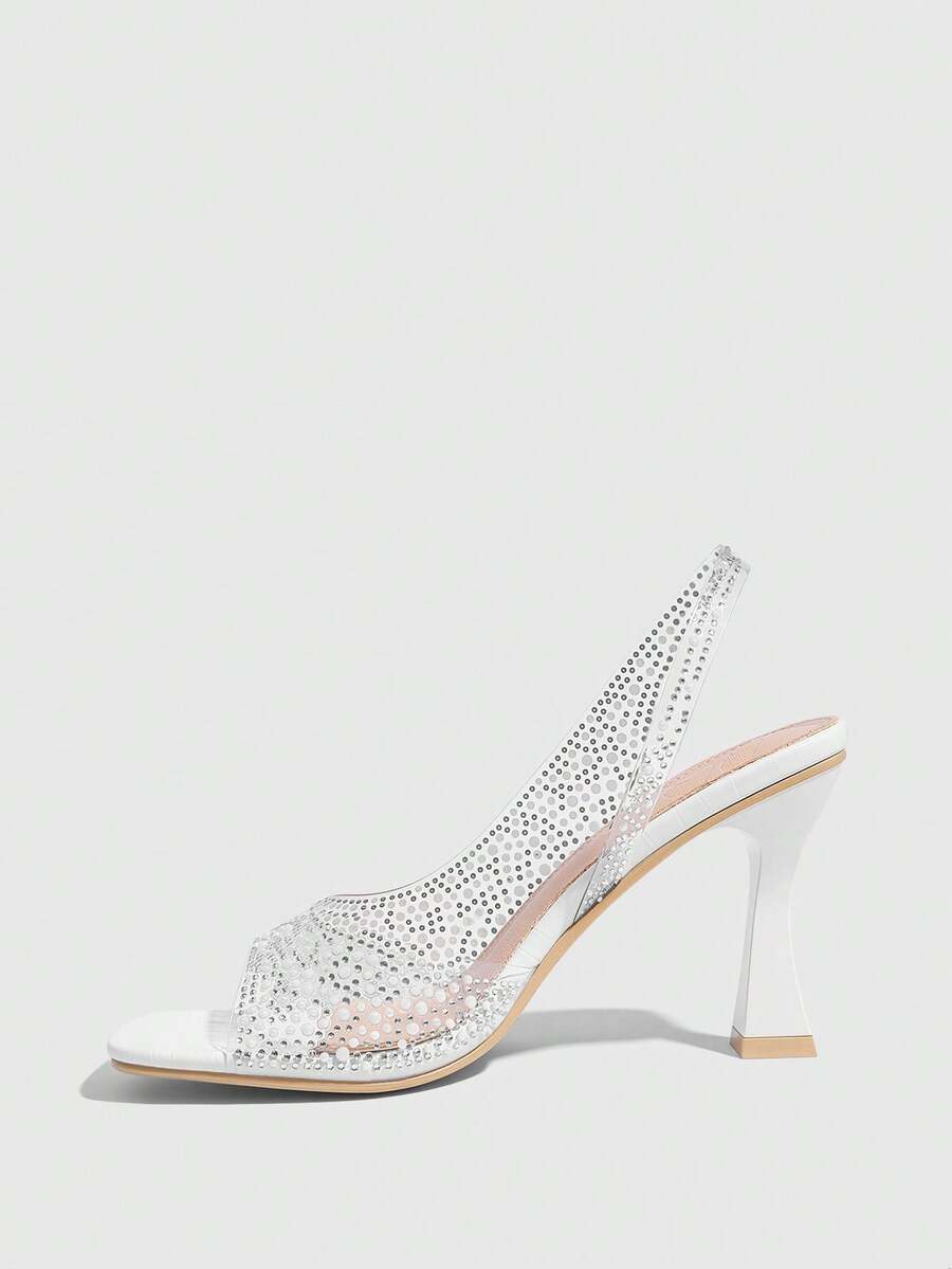 Women's square toe heeled sandals with clear straps, sparkling rhinestone embellishments, and a high pyramid heel.