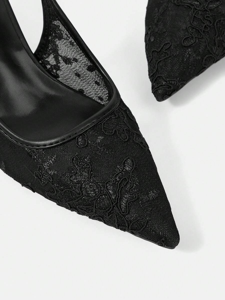 Pointed toe stiletto high heel pumps featuring black lace mesh upper, buckle slingback detail, and sleek slip-on design for weddings and evening wear.