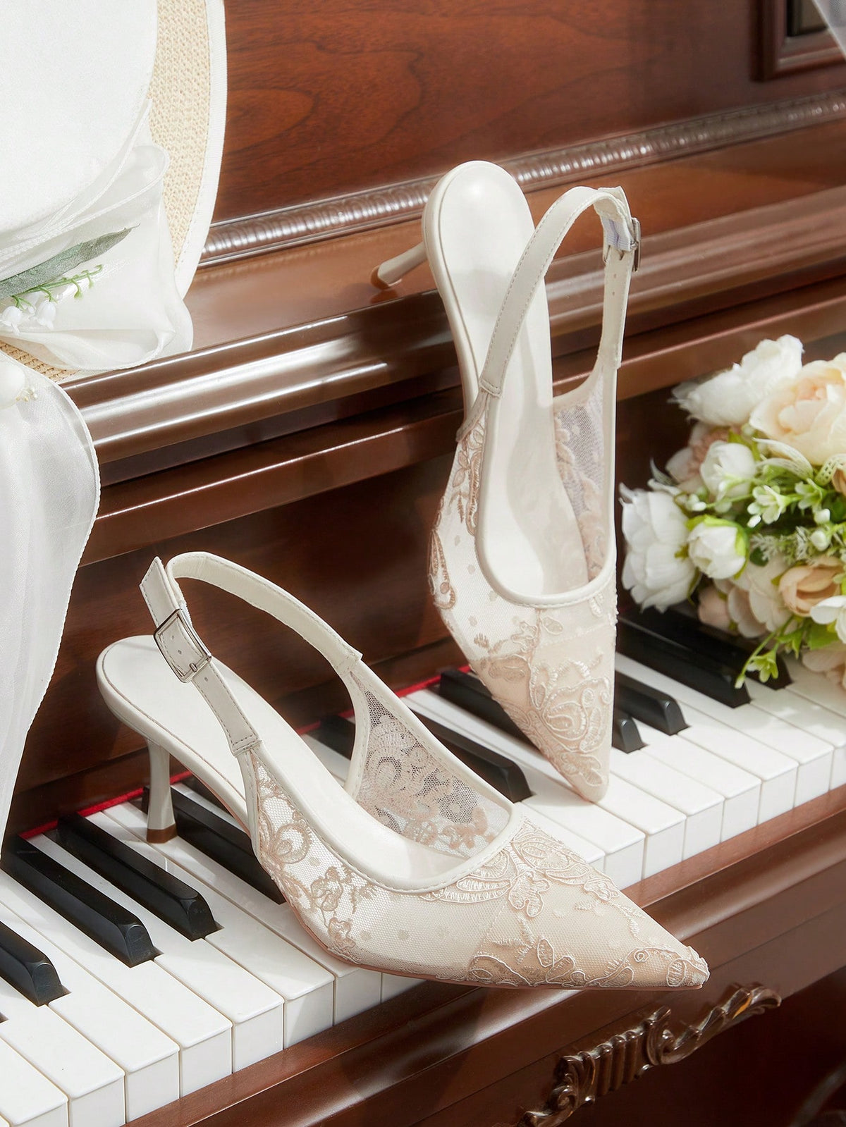 Pointed toe stiletto high heel pumps featuring black lace mesh upper, buckle slingback detail, and sleek slip-on design for weddings and evening wear.