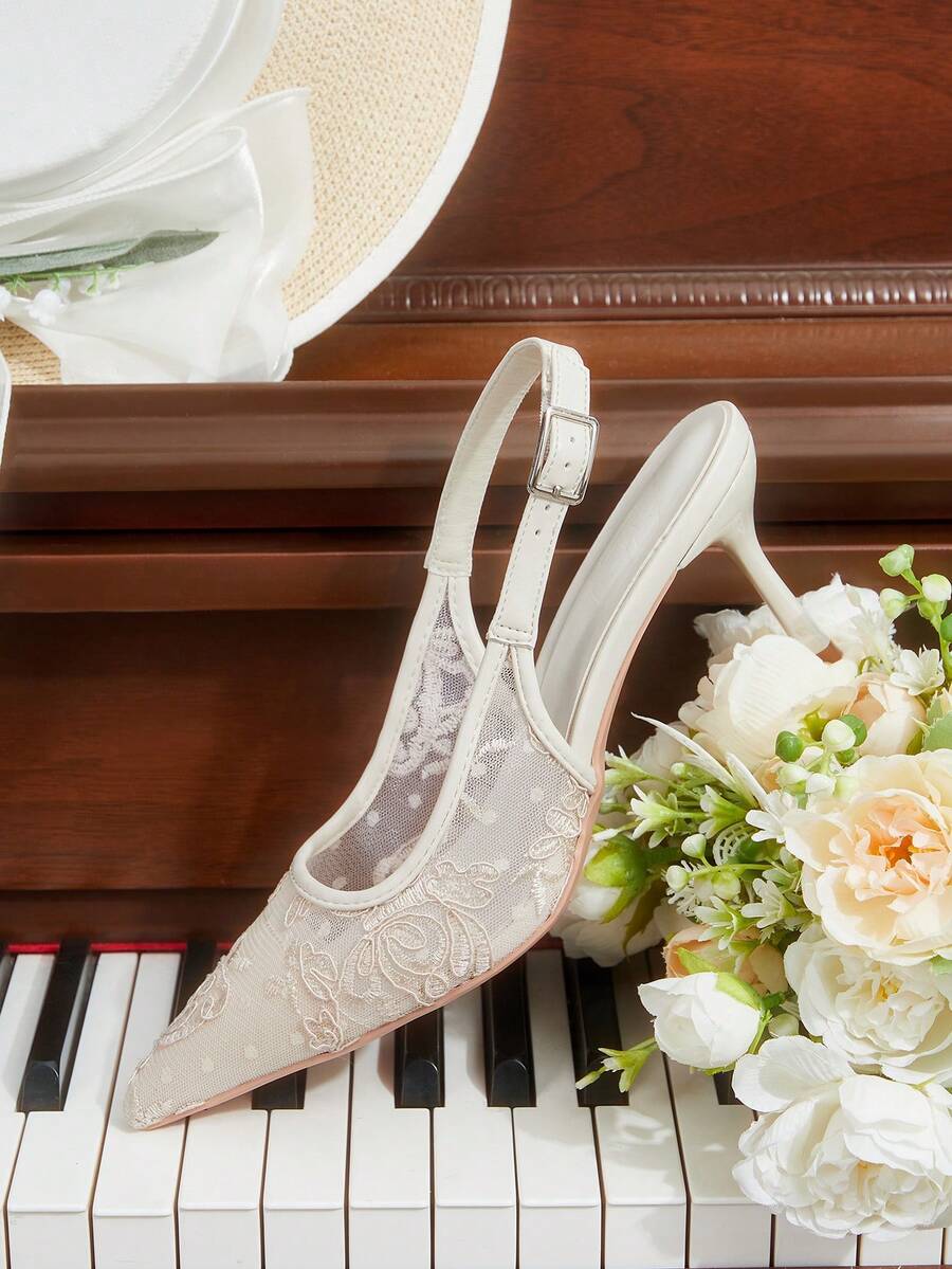 Pointed toe stiletto high heel pumps featuring black lace mesh upper, buckle slingback detail, and sleek slip-on design for weddings and evening wear.