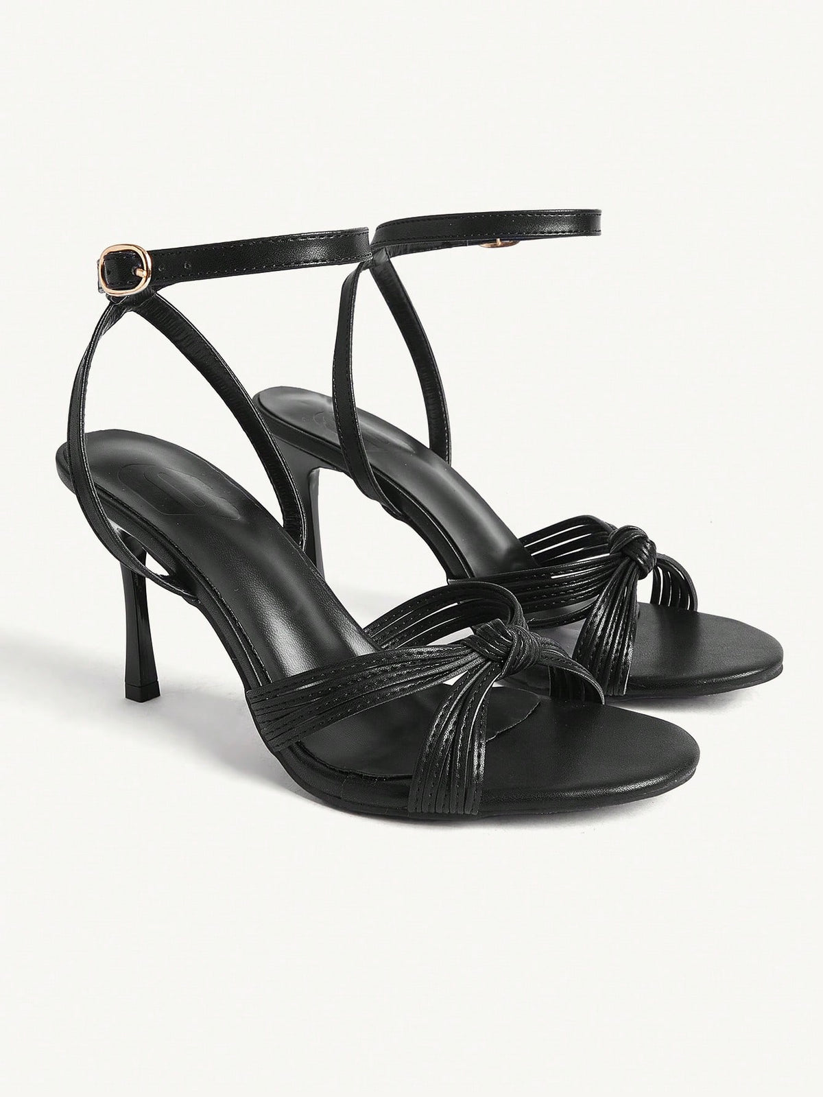 Women's champagne stiletto high heel sandals featuring knotted cross-over straps, open round toe, and adjustable ankle buckle strap.