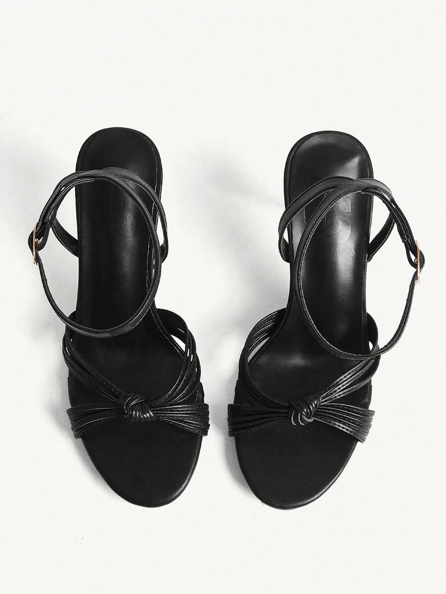 Women's champagne stiletto high heel sandals featuring knotted cross-over straps, open round toe, and adjustable ankle buckle strap.