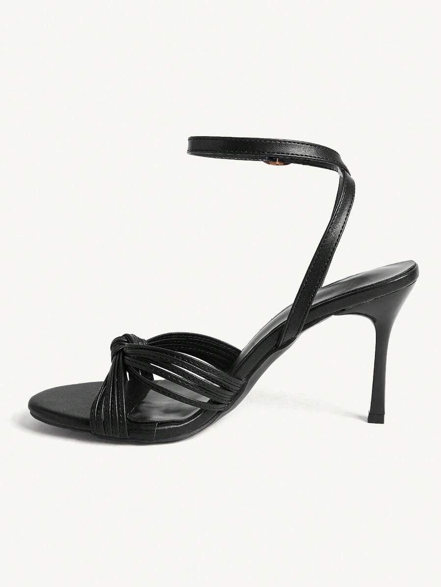 Women's champagne stiletto high heel sandals featuring knotted cross-over straps, open round toe, and adjustable ankle buckle strap.