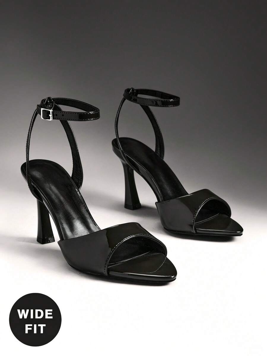 Women's wide-fit stiletto heel sandals featuring an open-toe design, slender mid stiletto heel, and adjustable ankle strap.