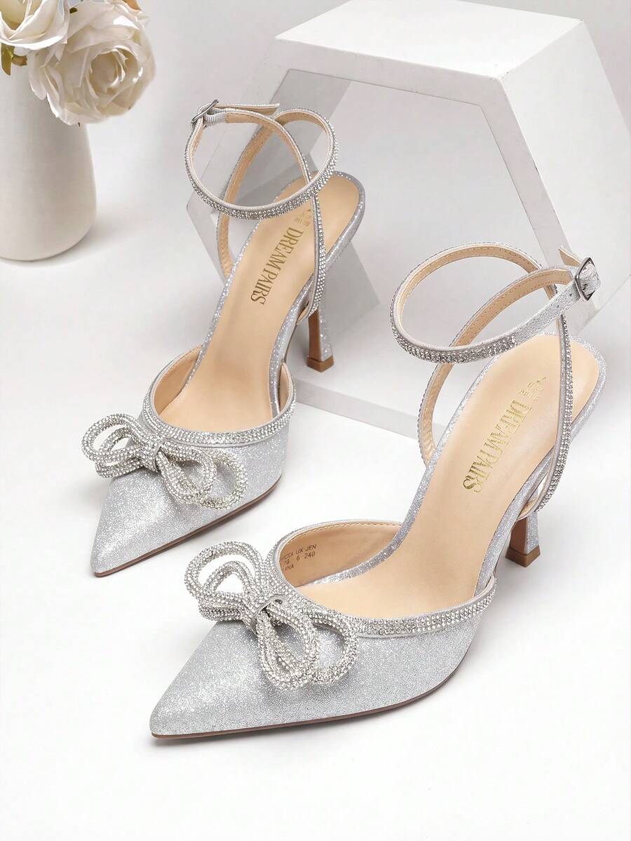Women's rhinestone ankle strap high heels with pointed closed toe, strappy bow details, and stiletto heel for wedding and prom wear.