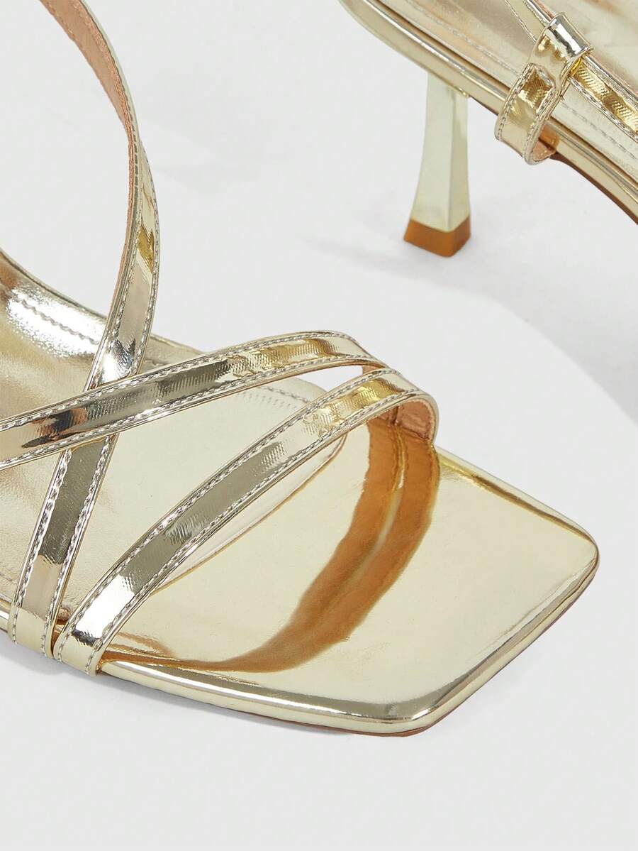 Women's open toe stiletto heel sandals featuring square toe design, criss-cross rhinestone slim straps, and secure ankle strap.