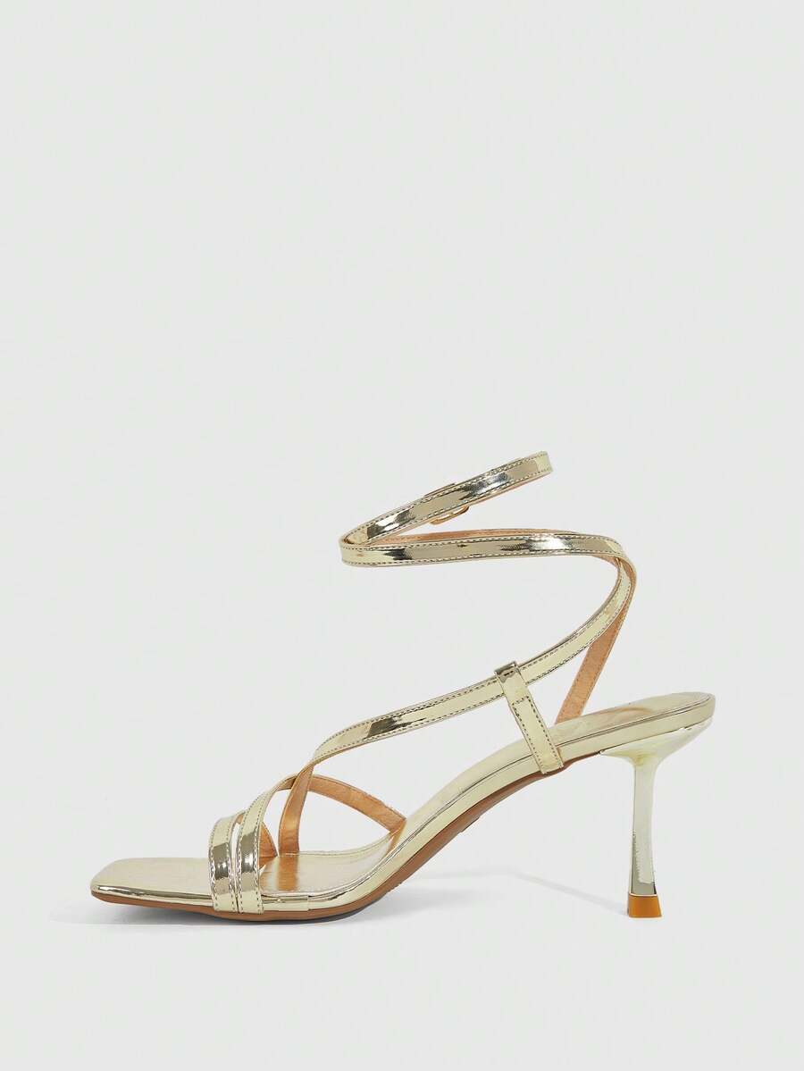 Women's open toe stiletto heel sandals featuring square toe design, criss-cross rhinestone slim straps, and secure ankle strap.