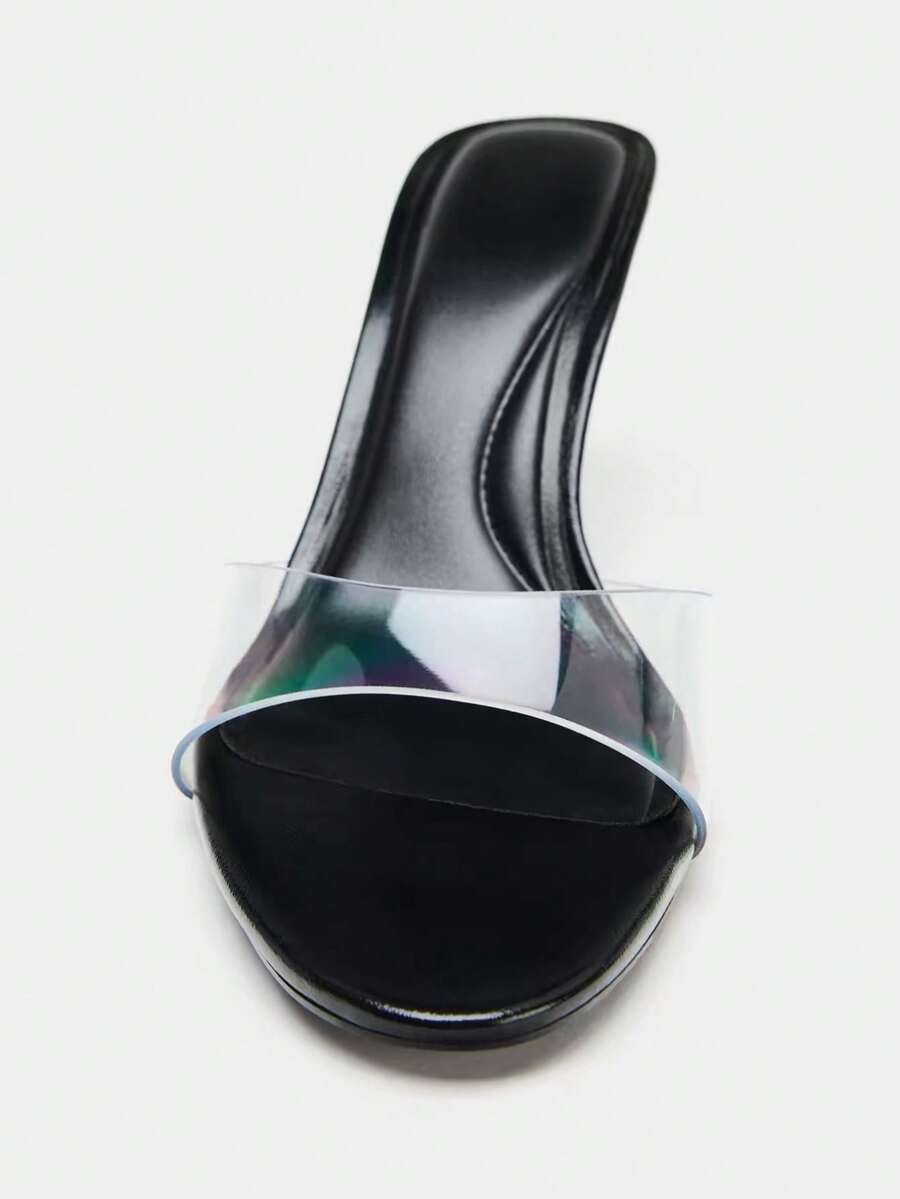 Pair of women's open toe patent leather mule shoes with sleek stiletto heels and cut-out styling