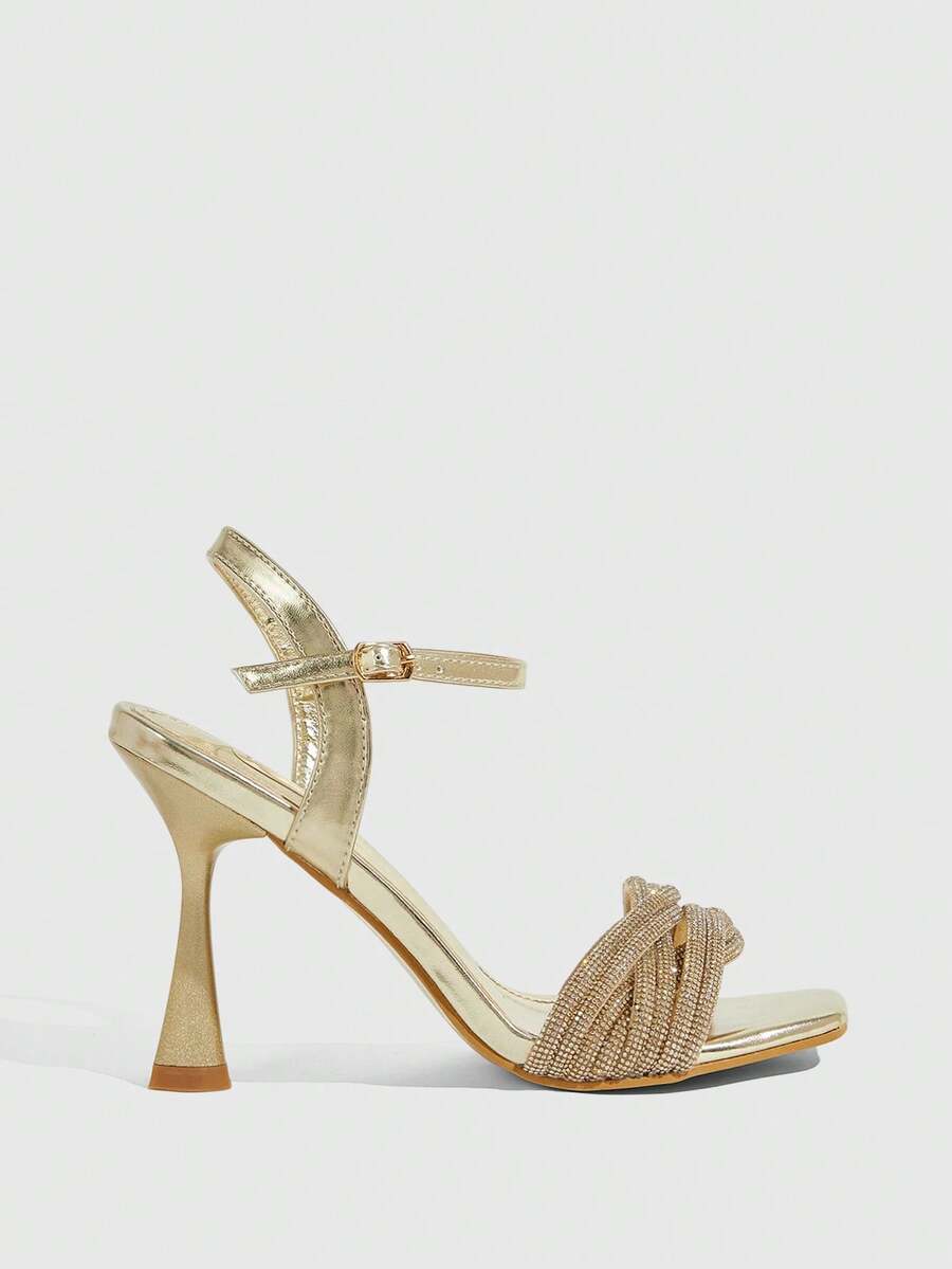 Women's gold open square toe high-heeled sandals featuring a stylish twist strap and stiletto heel.