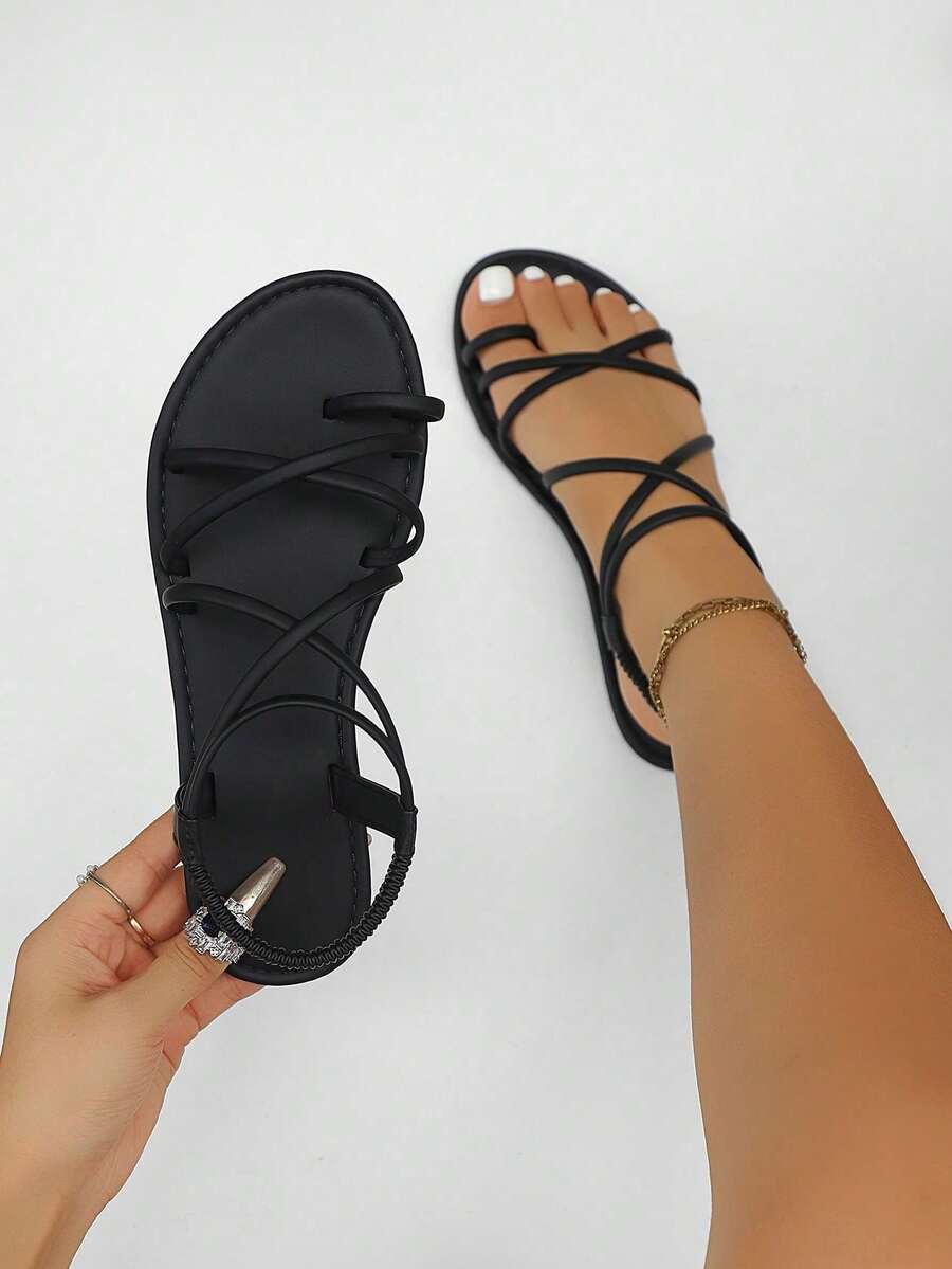 Women's lace-up flat slip-on sandals with round toe and hollow-out PU leather straps for beach and daily wear.