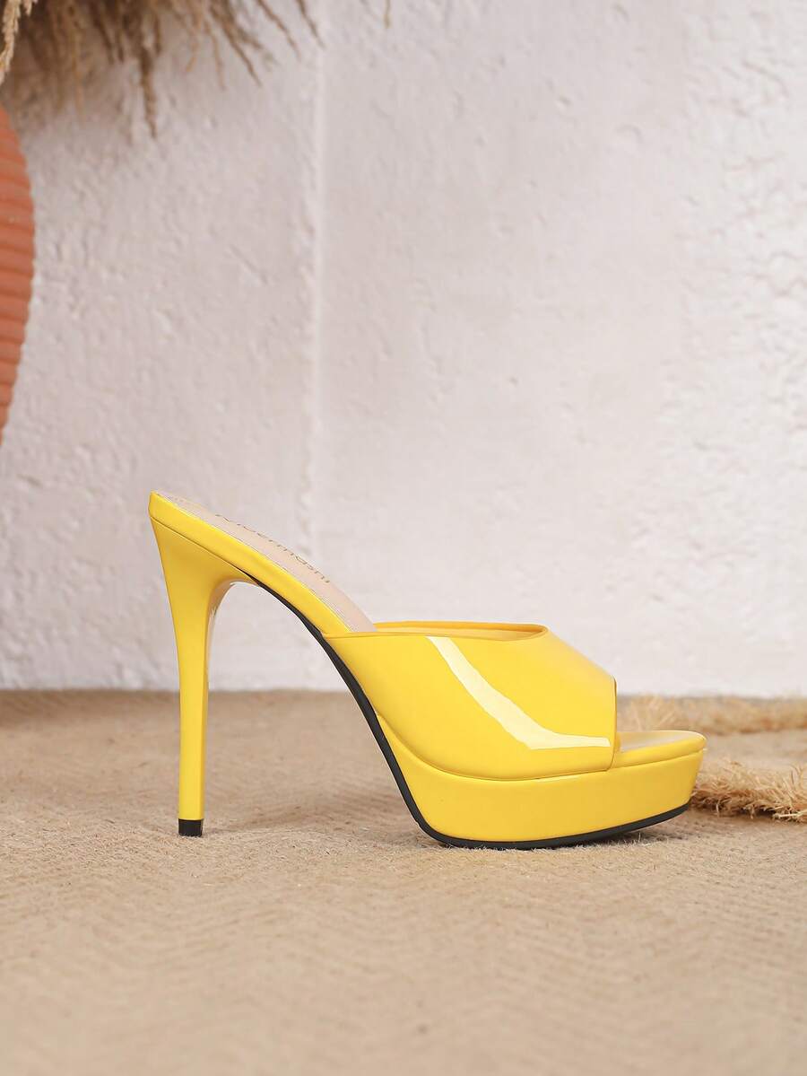 Women's patent leather stiletto heel sandals with open toe ruched slip on mule design.