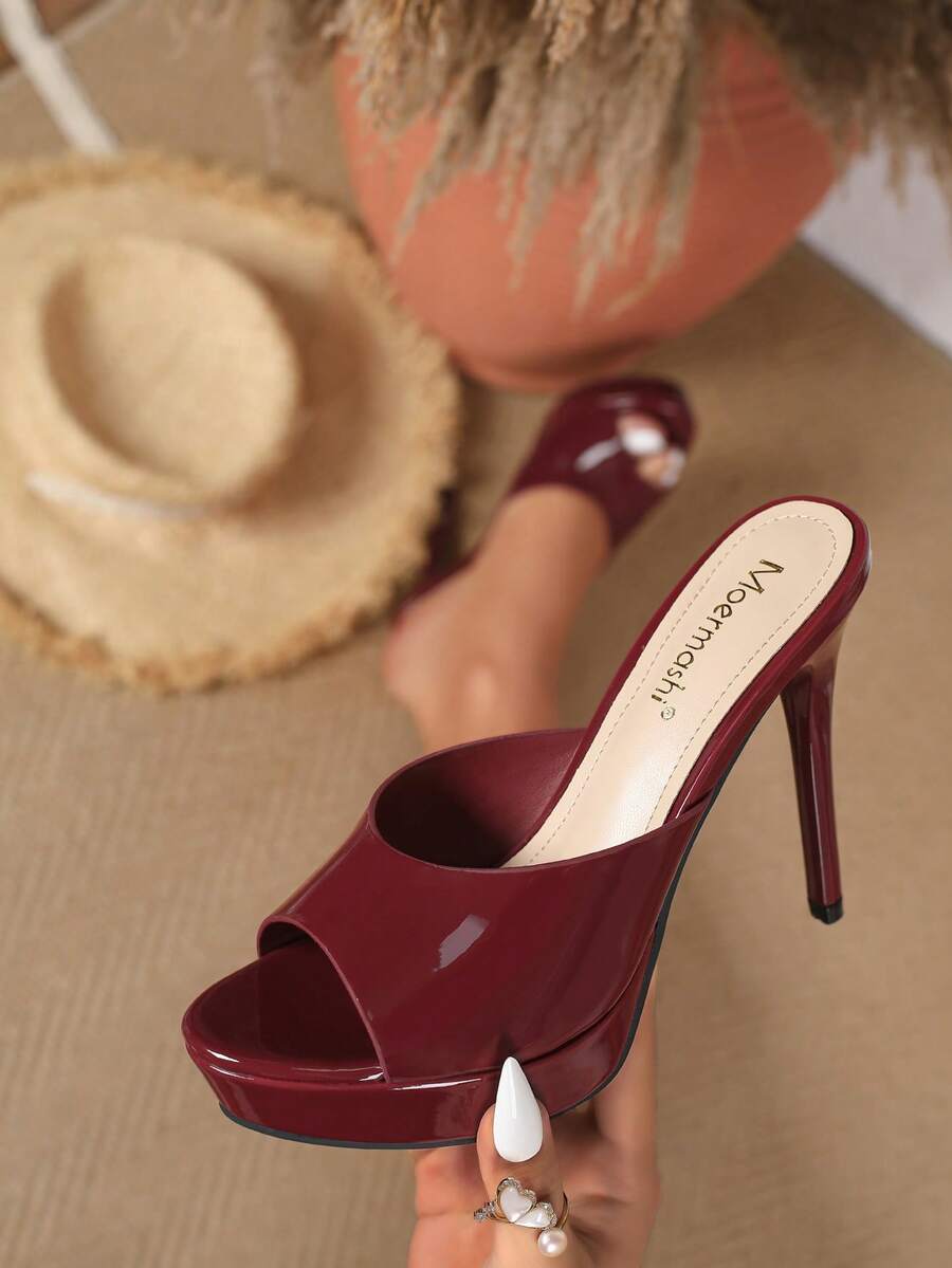 Women's patent leather stiletto heel sandals with open toe ruched slip on mule design.