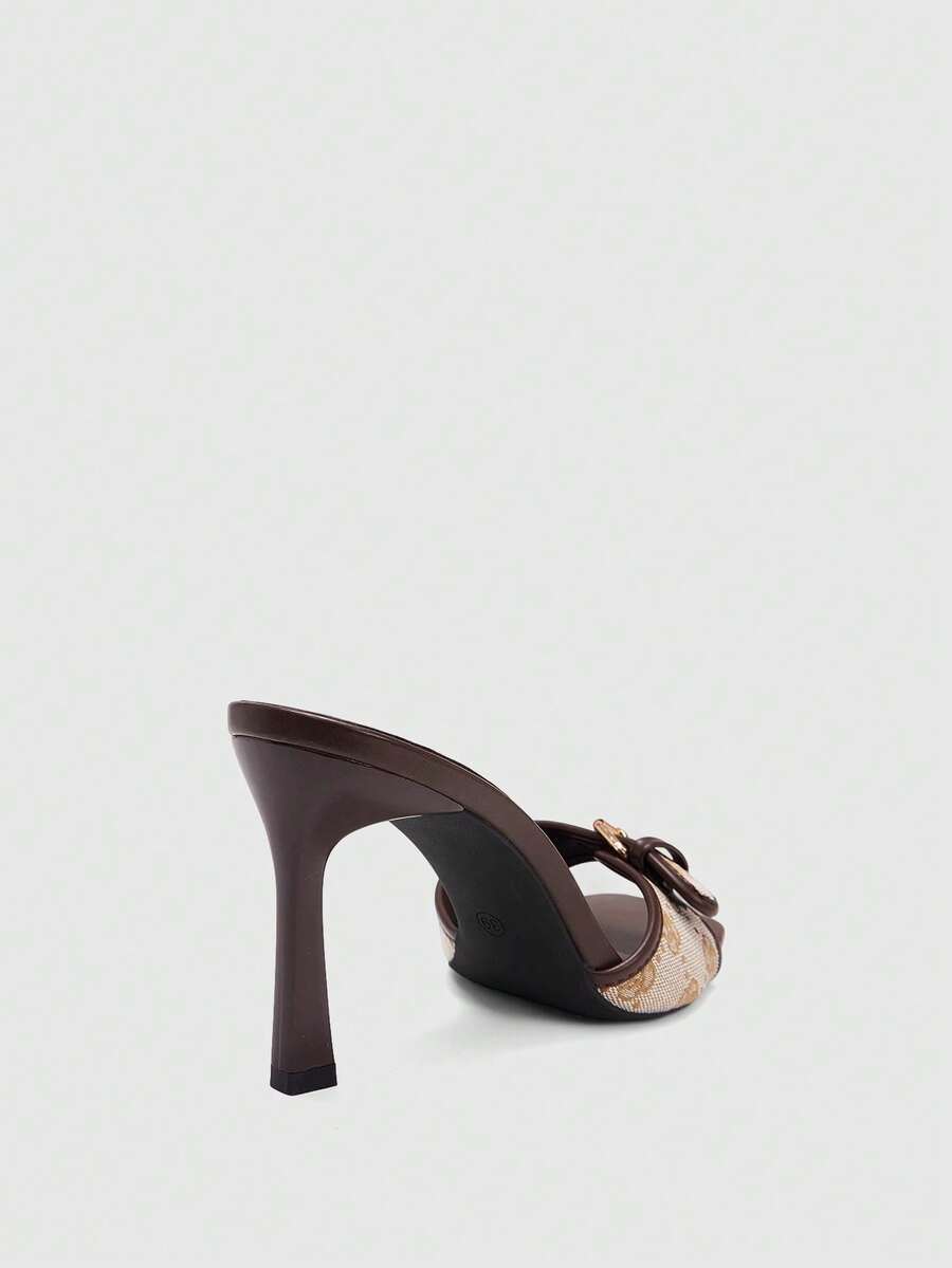 Women's brown open-toe slingback heeled sandals with stiletto heel and buckle strap.