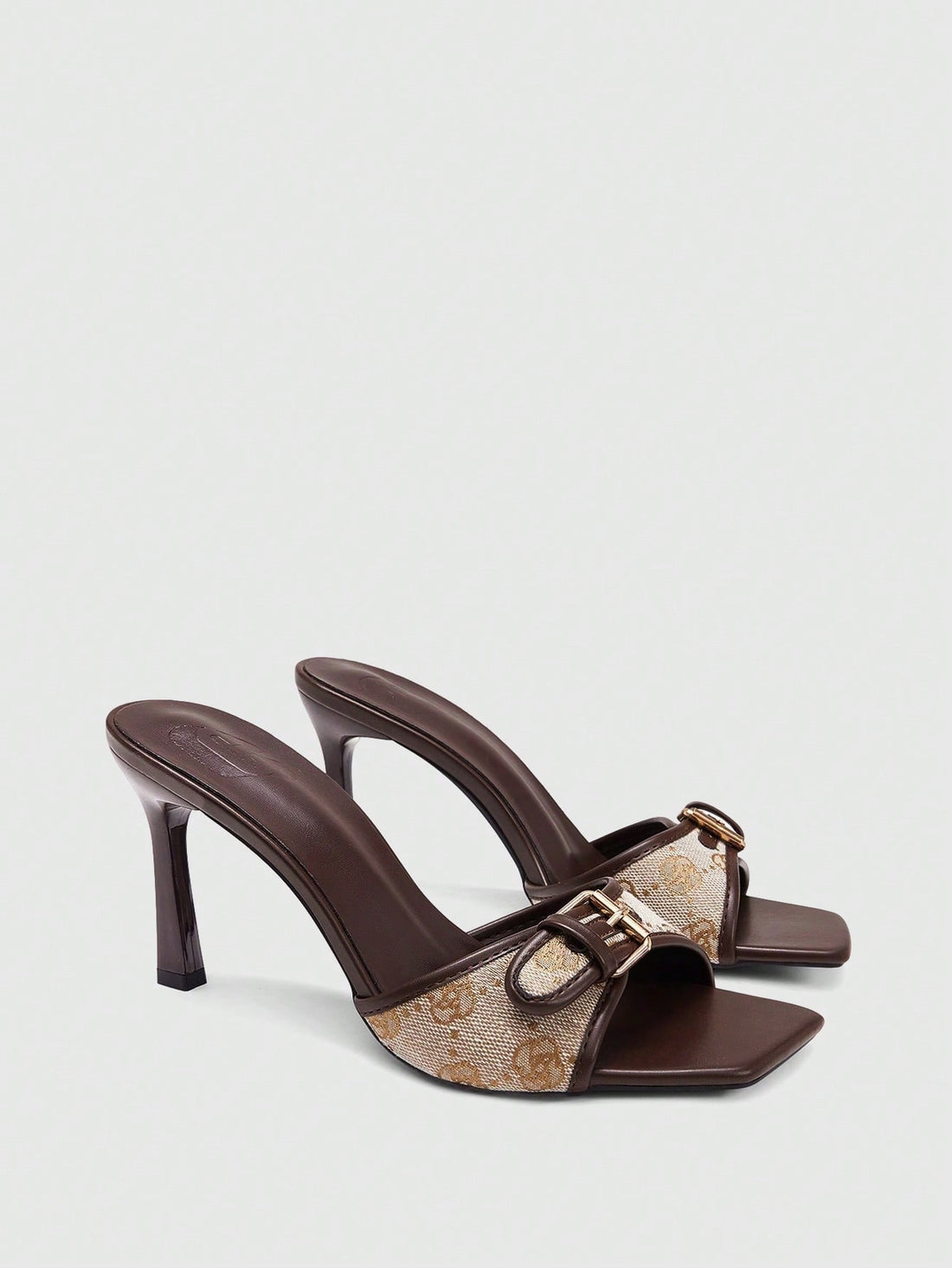 Women's brown open-toe slingback heeled sandals with stiletto heel and buckle strap.