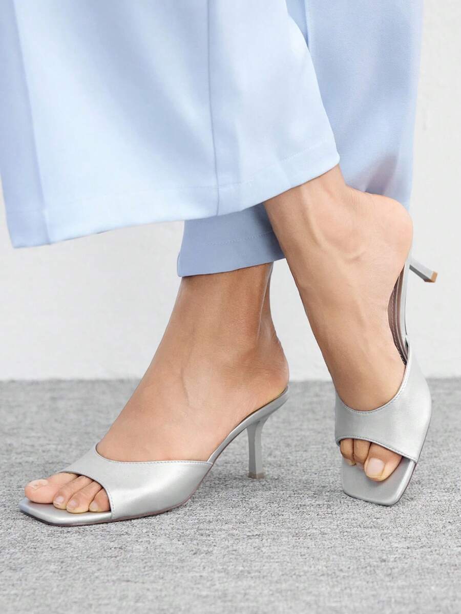 Women's black square toe high heel sandals featuring an open toe design, thin stiletto heel, and slingback strap.
