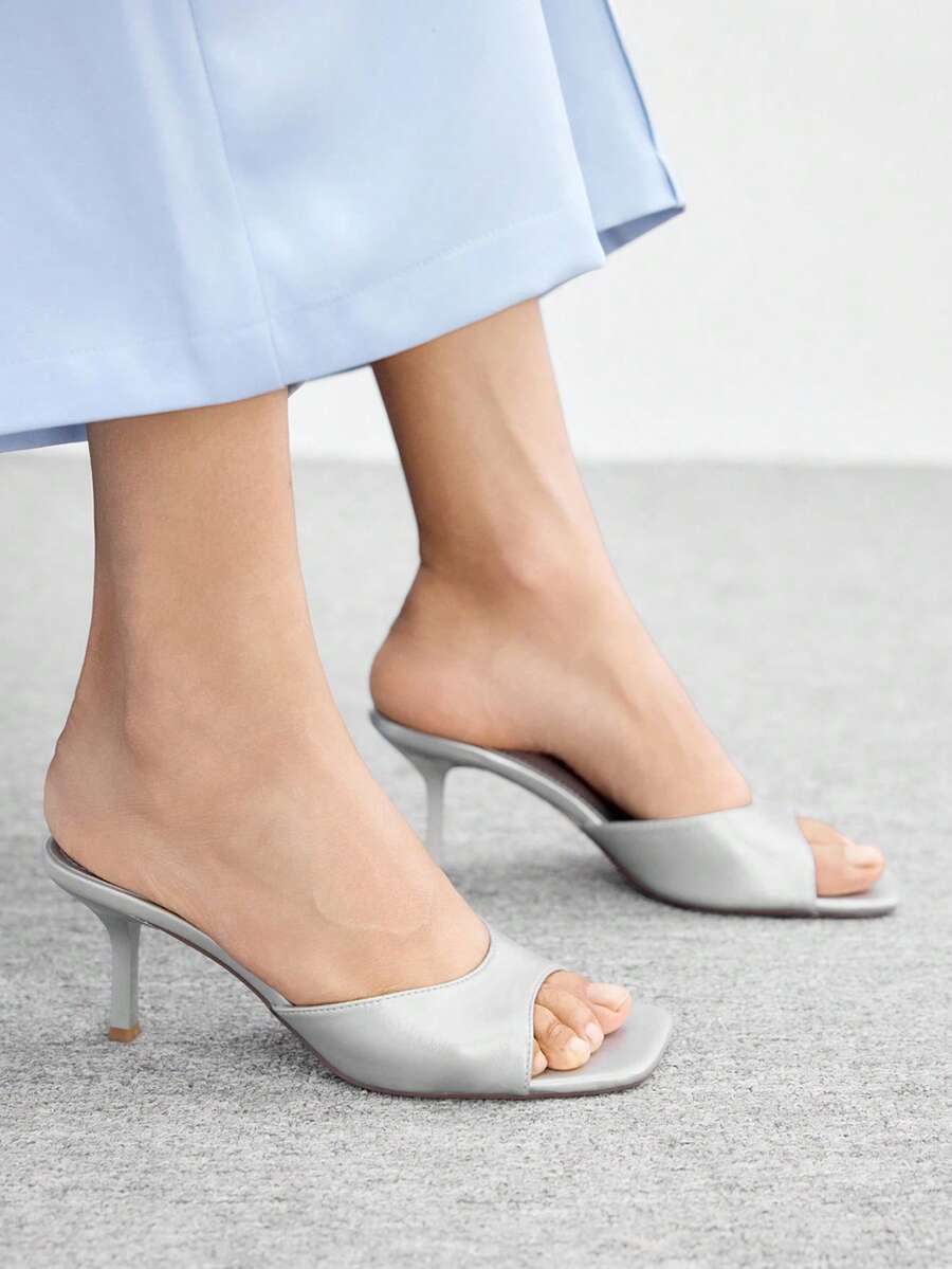 Women's black square toe high heel sandals featuring an open toe design, thin stiletto heel, and slingback strap.