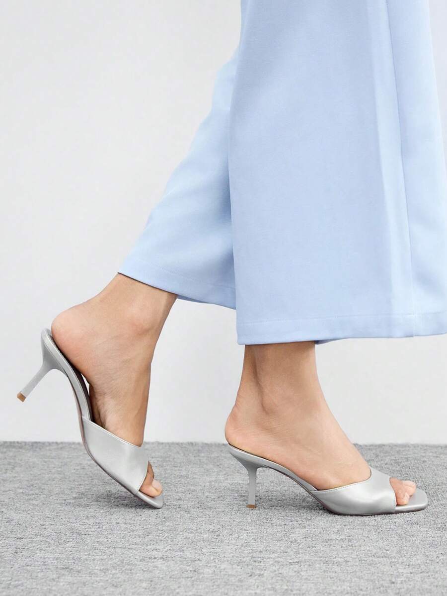 Women's black square toe high heel sandals featuring an open toe design, thin stiletto heel, and slingback strap.