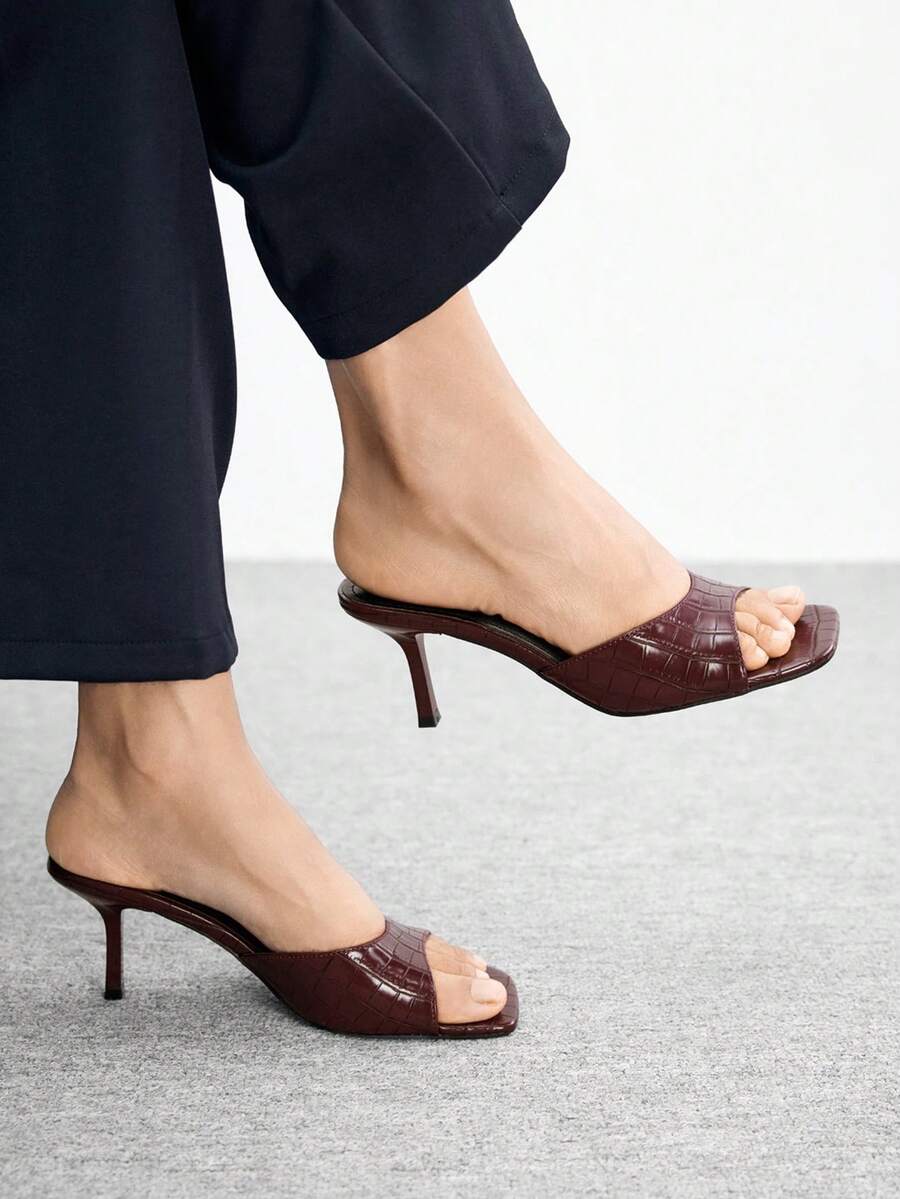Women's black square toe high heel sandals featuring an open toe design, thin stiletto heel, and slingback strap.