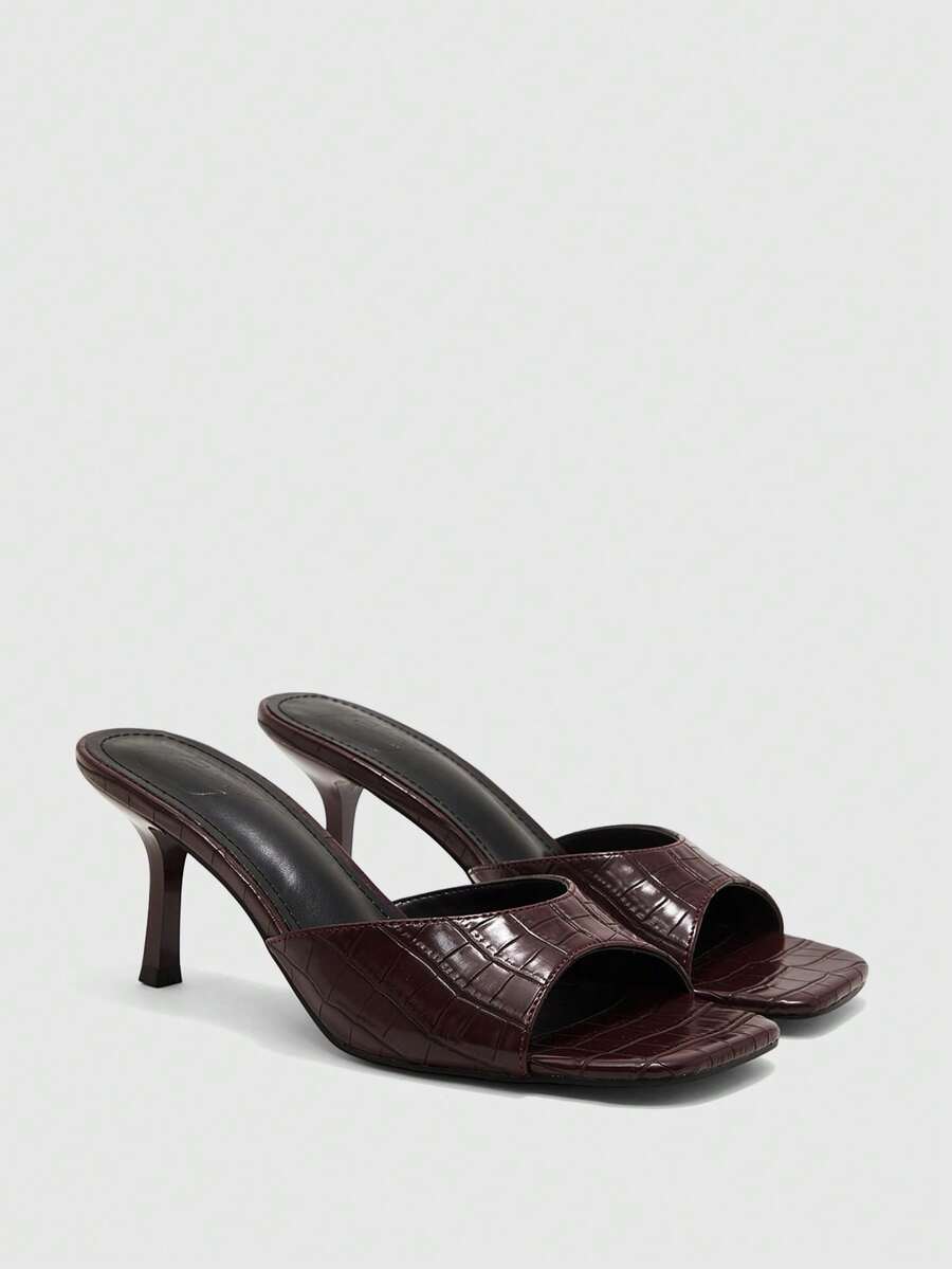 Women's black square toe high heel sandals featuring an open toe design, thin stiletto heel, and slingback strap.