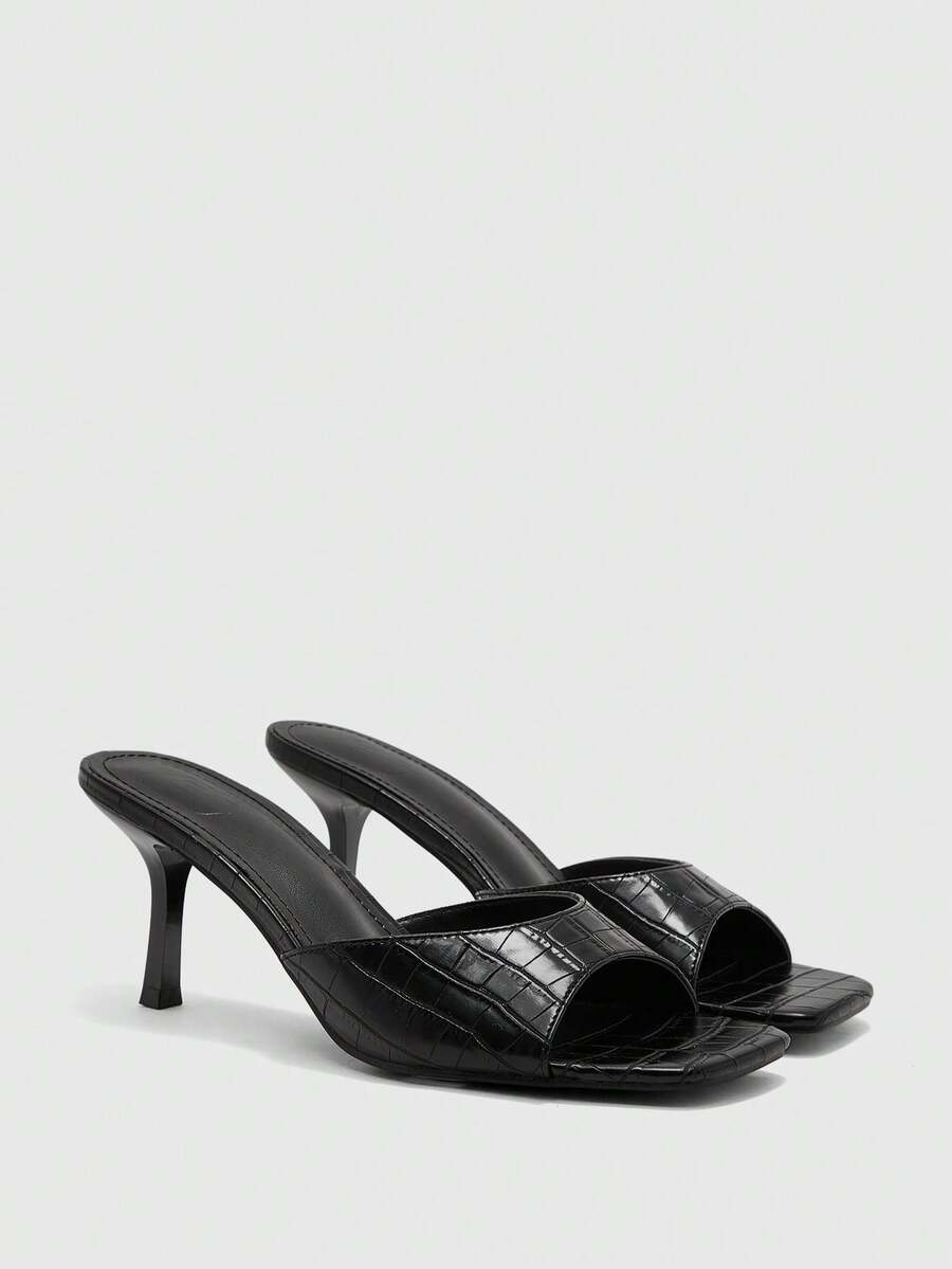 Women's black square toe high heel sandals featuring an open toe design, thin stiletto heel, and slingback strap.
