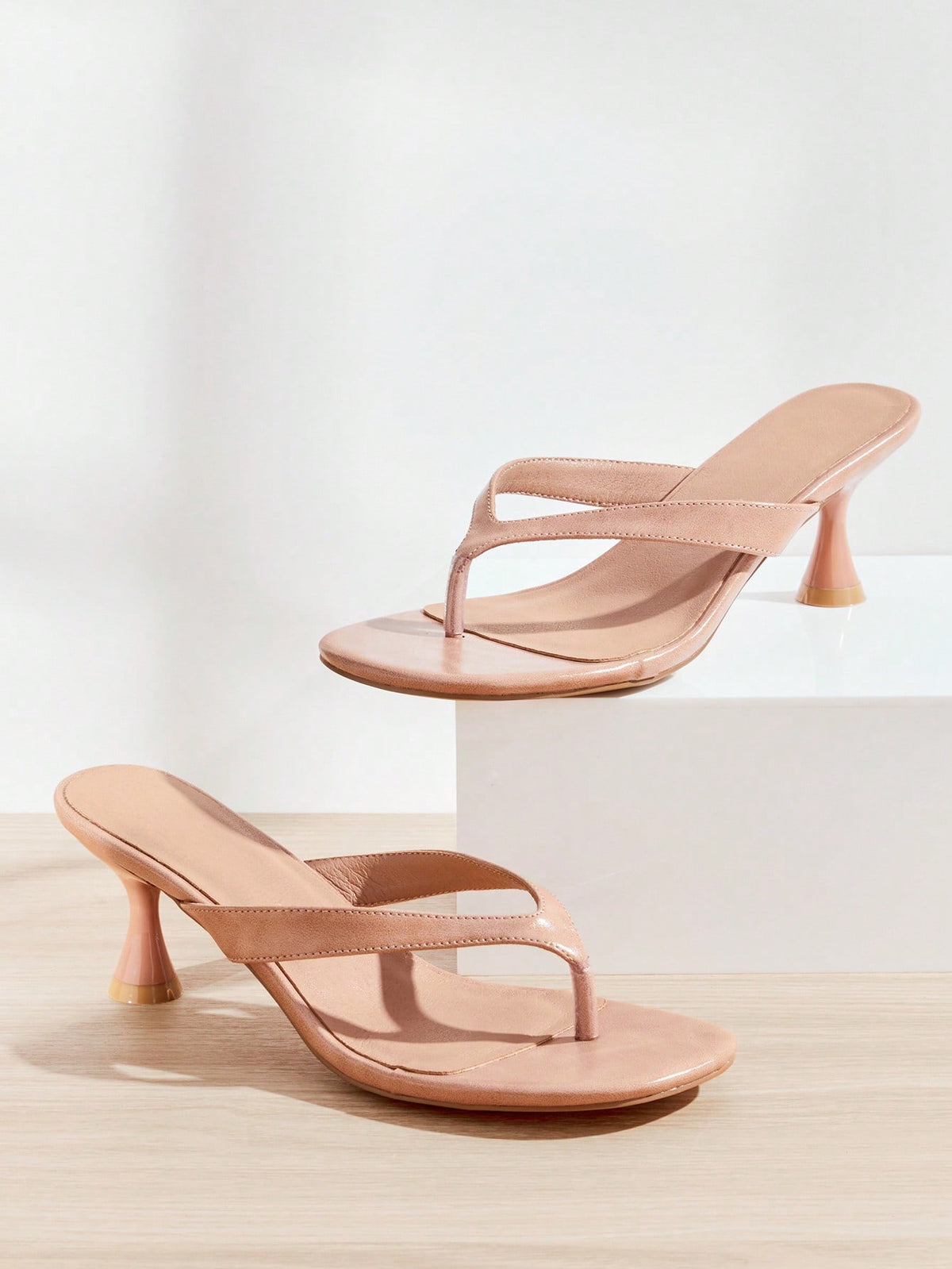 Women's minimalist black PU leather thong heel sandals featuring kitten heels and rhinestone accents