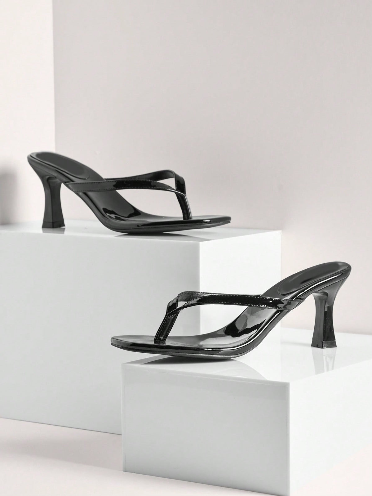 Women's minimalist black PU leather thong heel sandals featuring kitten heels and rhinestone accents